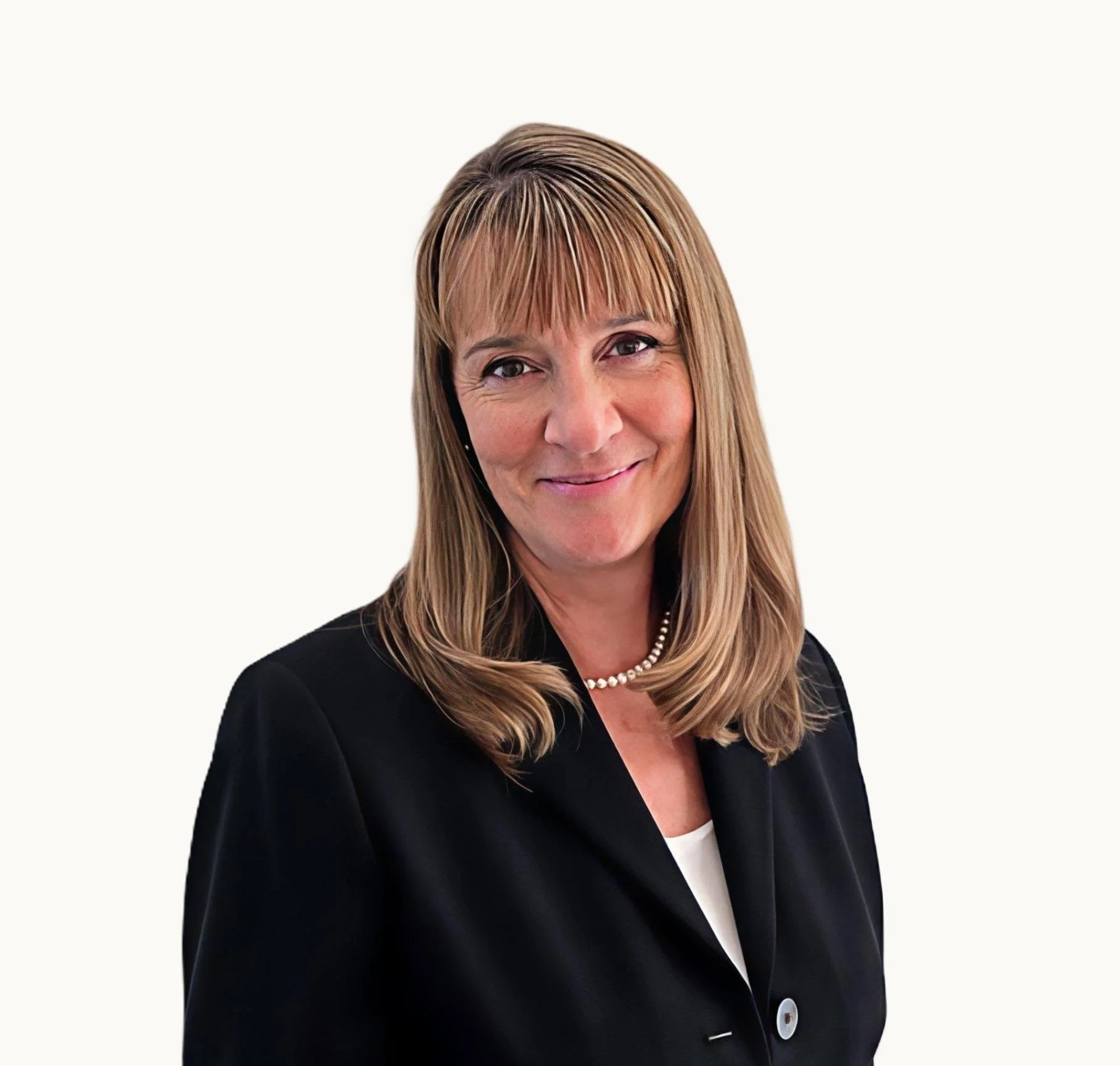 A professional woman with shoulder-length light brown hair, wearing a black blazer, a white top, and a pearl necklace, smiling at the camera against a plain white background.