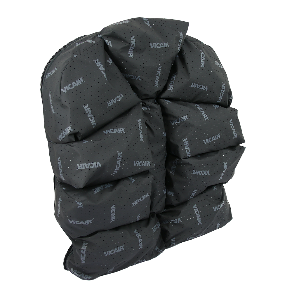 A black recliner chair wrapped in a protective cover with the brand name VICAIR printed repeatedly.