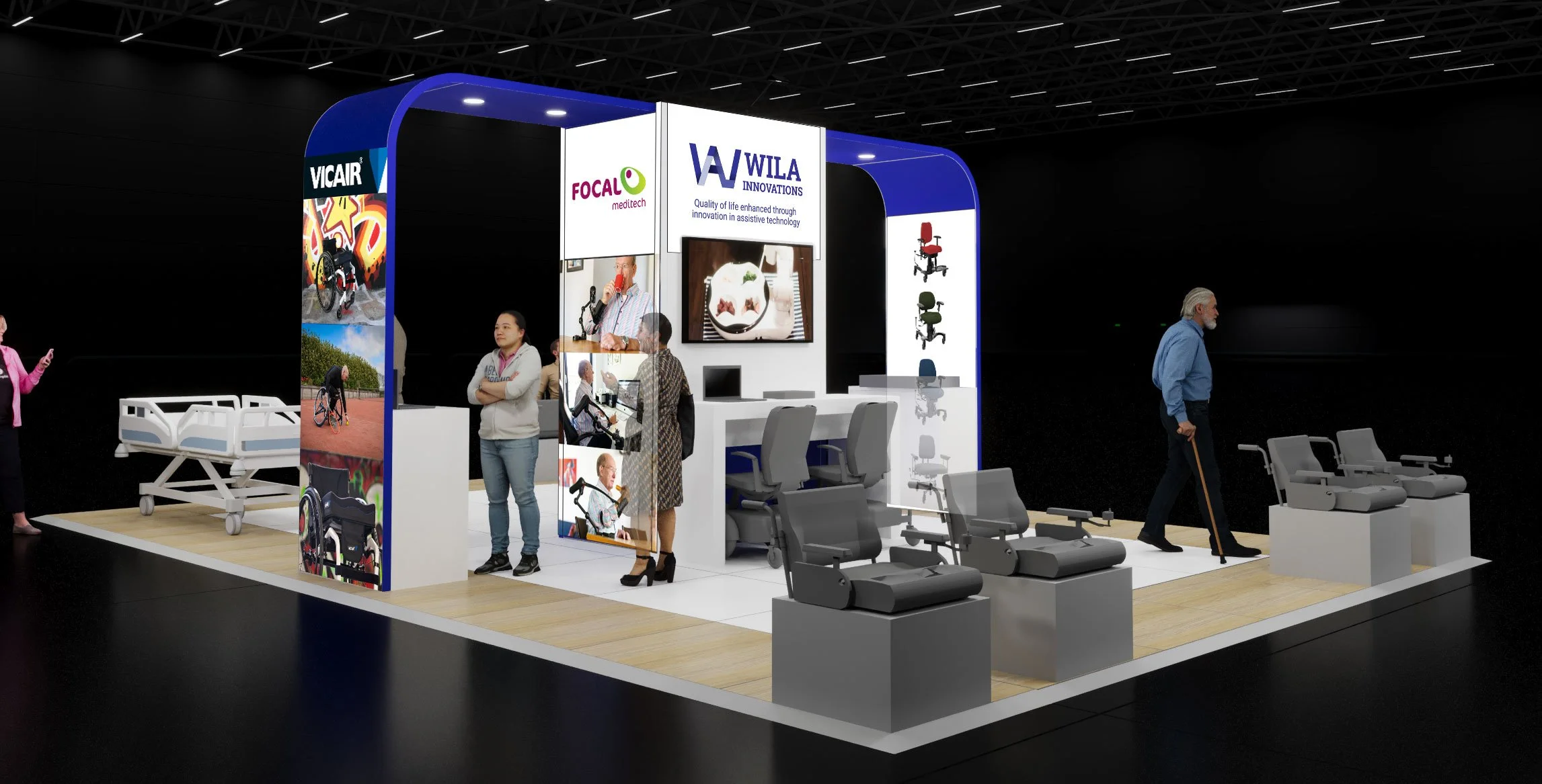 Exhibition booth displaying various seating and mobility products, with posters of people using wheelchairs, and company logos for Vicair, Focal Meditech, and Wila Innovations.