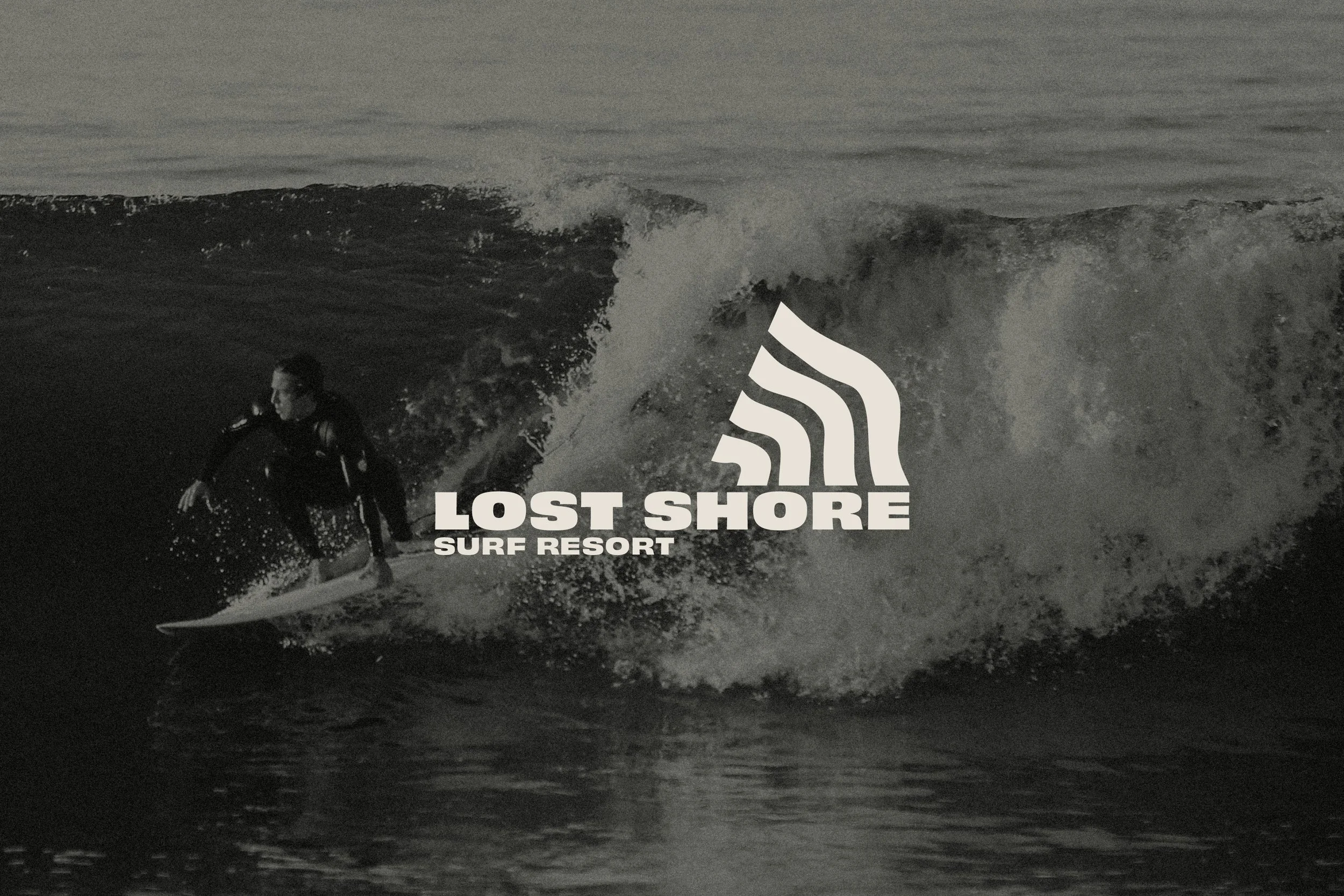 A person surfing on a wave with the Lost Shore Surf Resort logo overlaying the image.