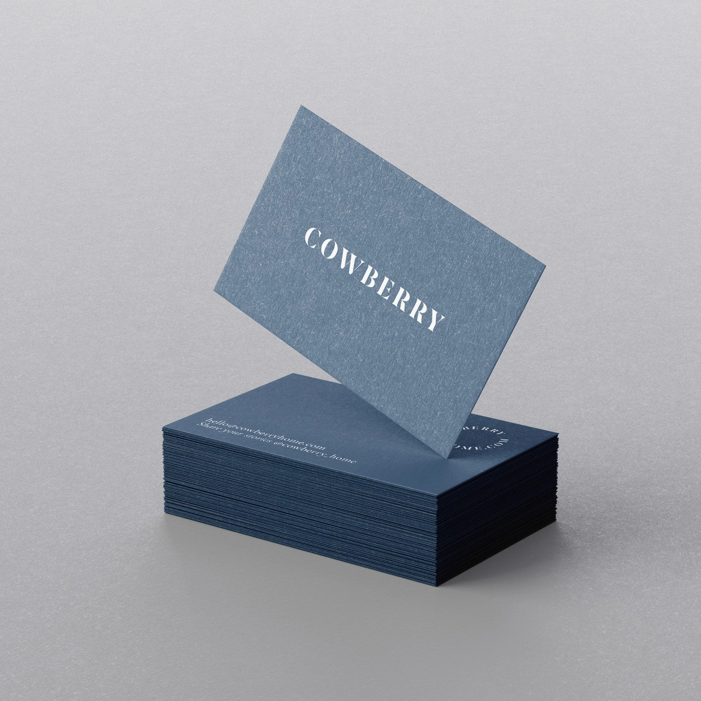 Stack of blue business cards with the word 'COVBERRY' in white letters, one card is lifted and tilted.