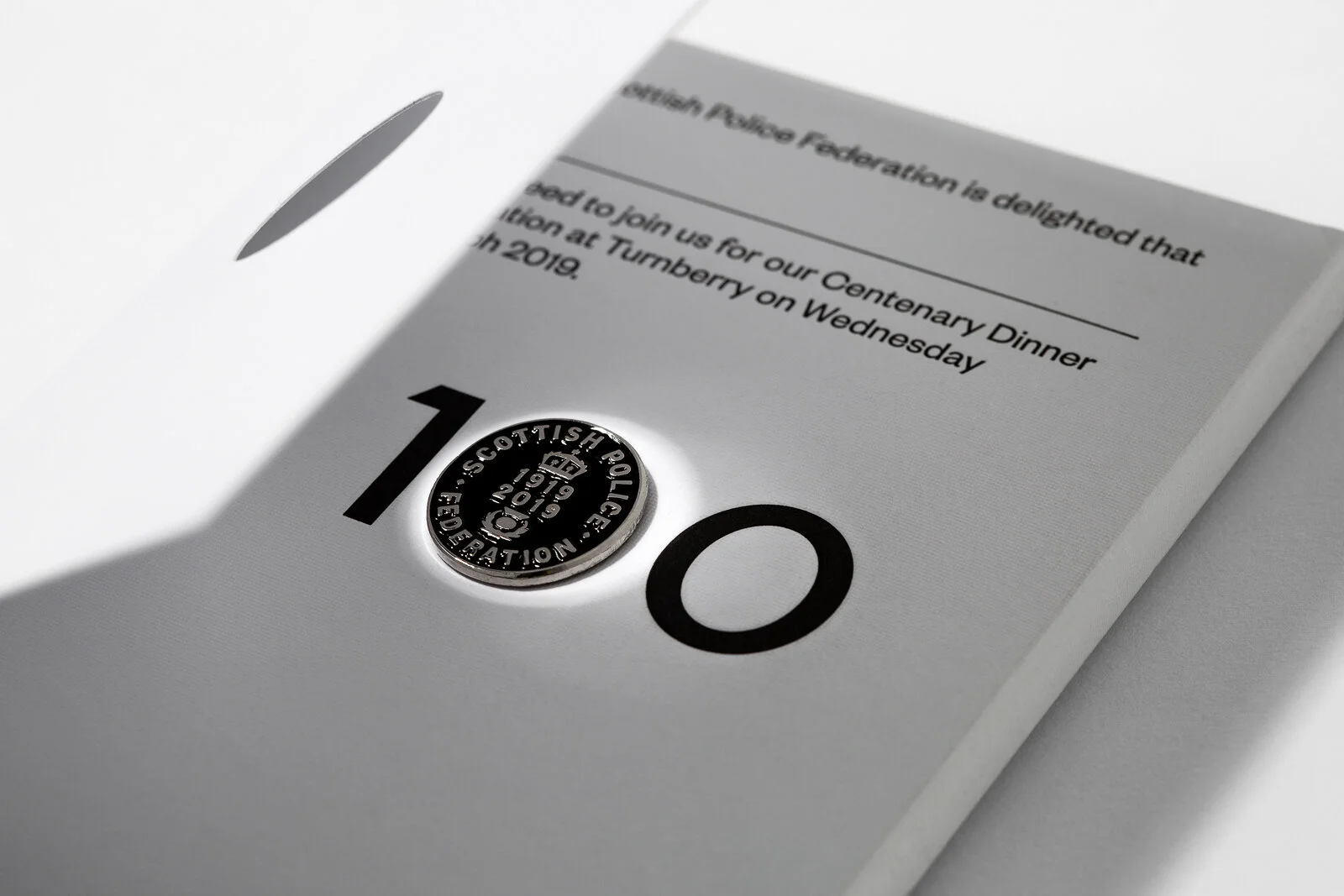 A ballot paper with a coin pressed into the number one spot, with the coin reading 'Scotland Police Federation, 1919-2019'.