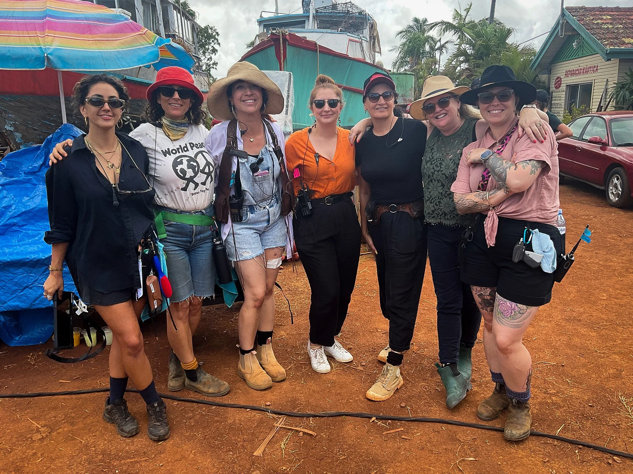 A group of eight women standing together outdoors on the set of the film ANACONDA
