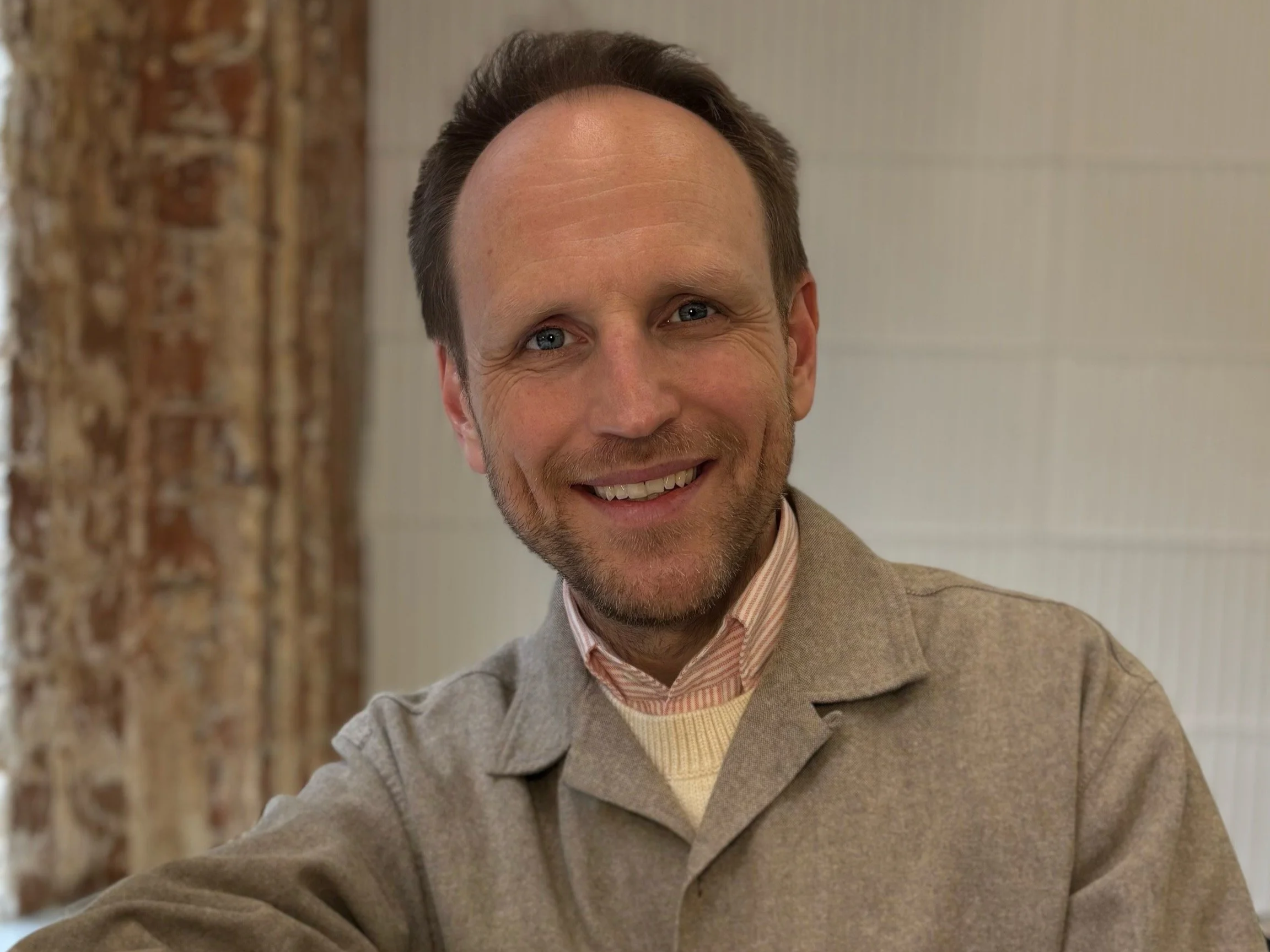 Greg Hill smiles for the camera at Josh Wood Salon in London