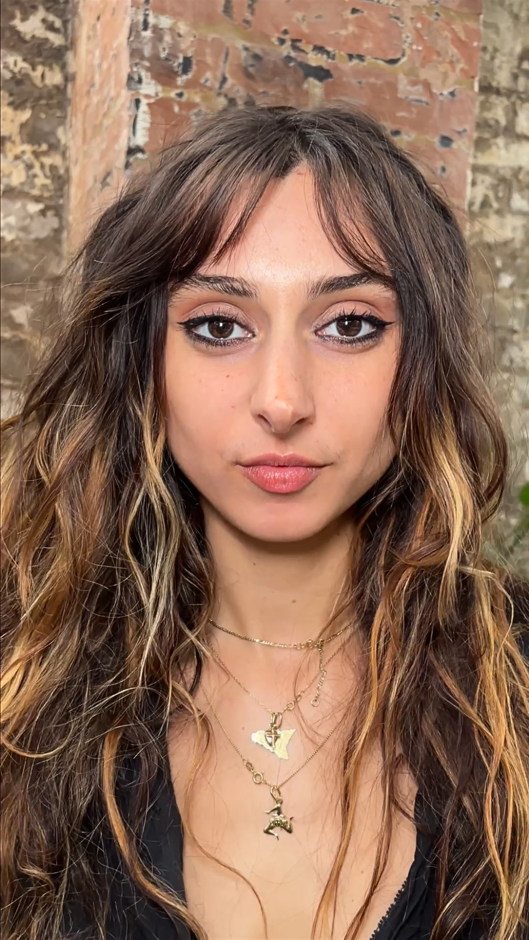 Long, naturally wavy hair with short face-framing pieces, styled by Greg Hill to enhance texture, shape, and movement.