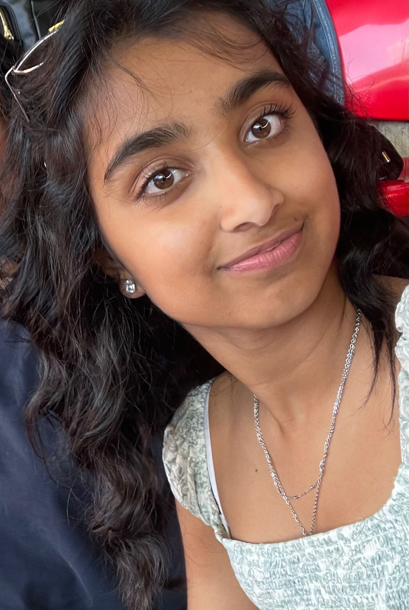 Group of dancers in a performance, some leaning back with heads tilted, on a stage with pink background and the words "LISTEN BRITNEY SPEARS" visible.