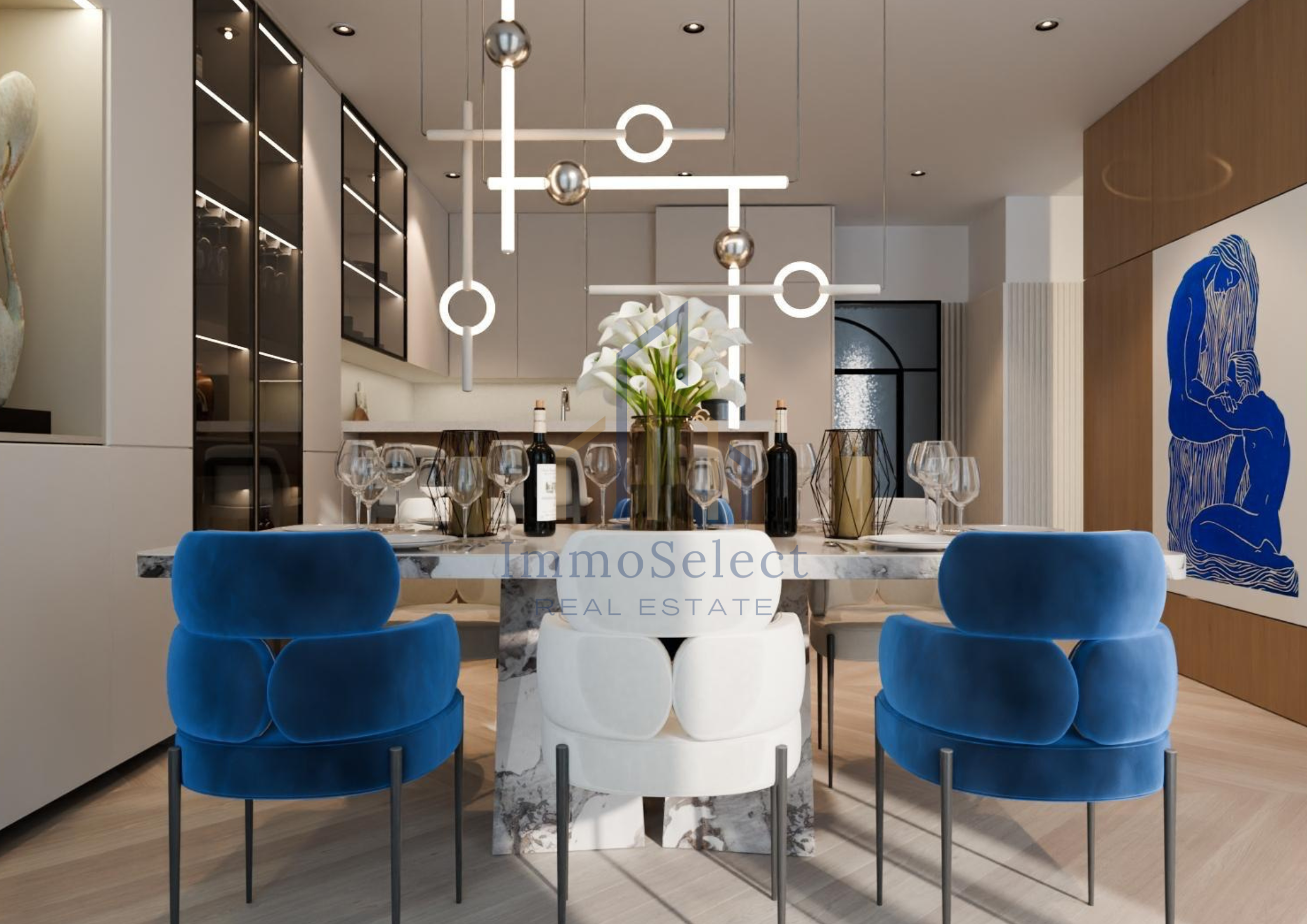 Modern dining room with a marble table, blue velvet chairs, a centerpiece of white lilies, wine bottles, glasses, and unique geometric pendant lighting. There's abstract blue wall art and a light wood paneled wall.