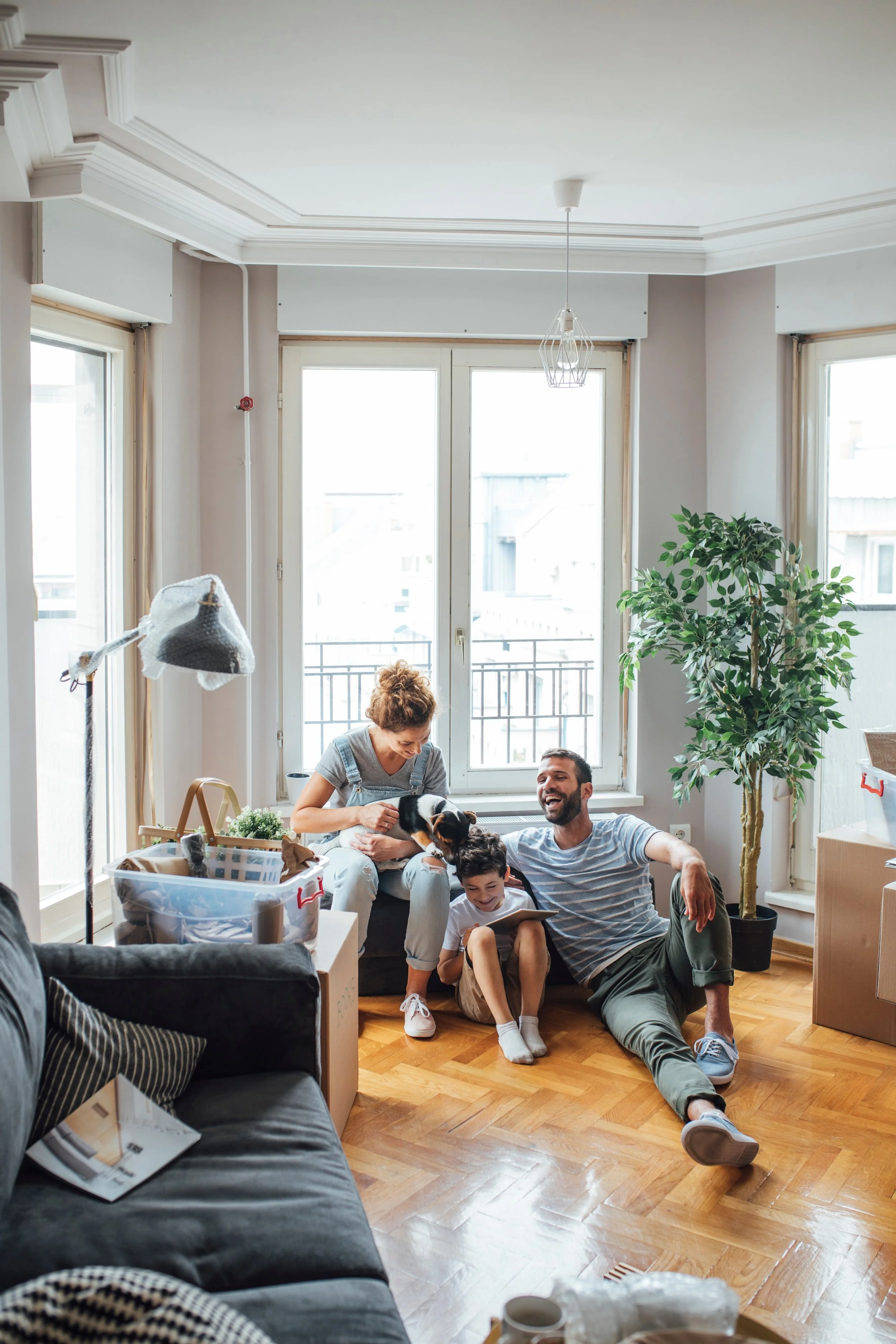 Family moving into new apartment smiling together