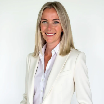 head shot of Laura Phillips with blonde hair, wearing a white suit and shirt, against a plain white background.