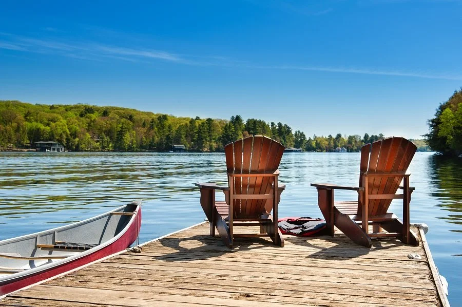 muskoka chairs on lakeside dock