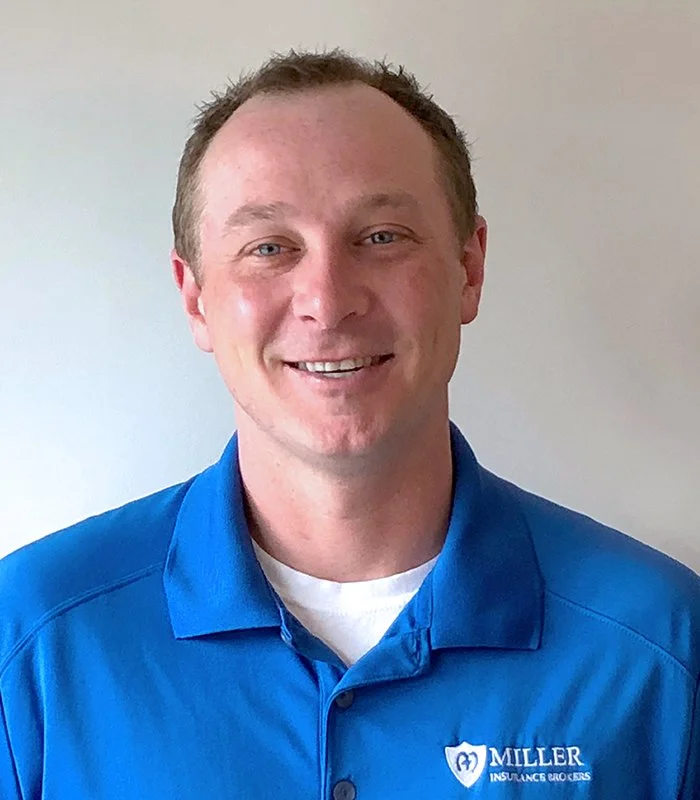 Dave McClory headshot with short brown hair wearing a blue polo shirt with Miller Insurance Brokers logo, smiling in front of a plain light-colored wall.