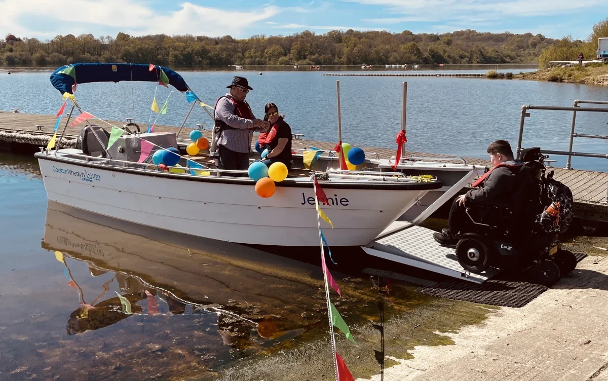 First wheelchair passenger boards purpose-built powerboat “Jennie” that features a roll-on/roll-off bow ramp.