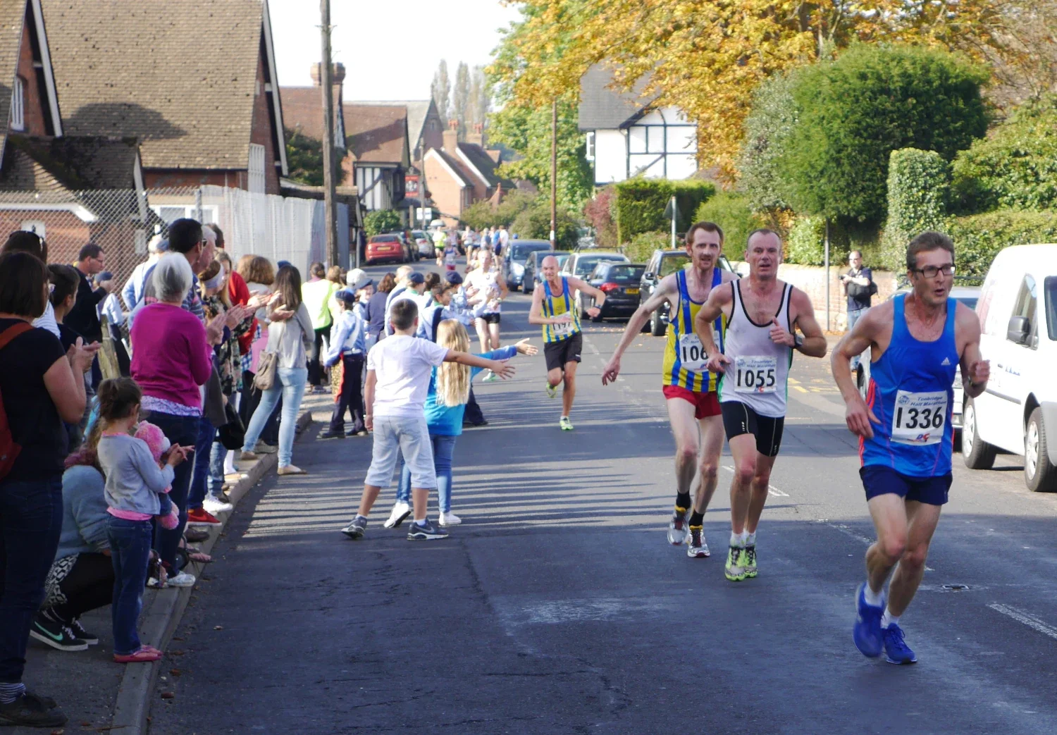 Tonbridge Half marathon runners being encouraged by spectators as they pass through Leigh