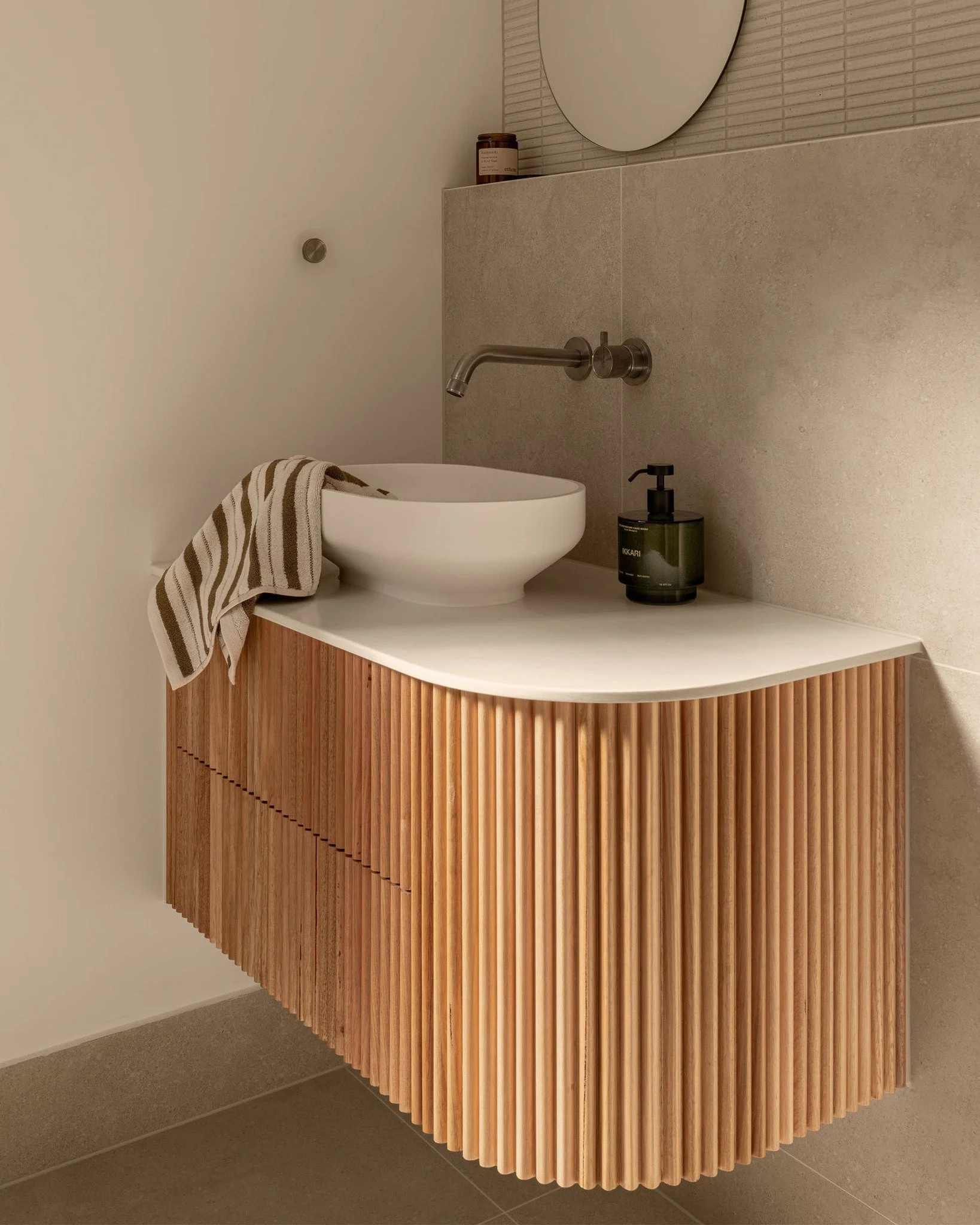 A sculptural vanity defined by soft curves and @porta_timber Tassie oak moulding, bringing warmth and texture into the space. 

Joinery &amp; Interiors for the Elizabeth St Project. 

#GullDesign #Joinery #Bathroom #BathroomJoinery #InteriorDesign