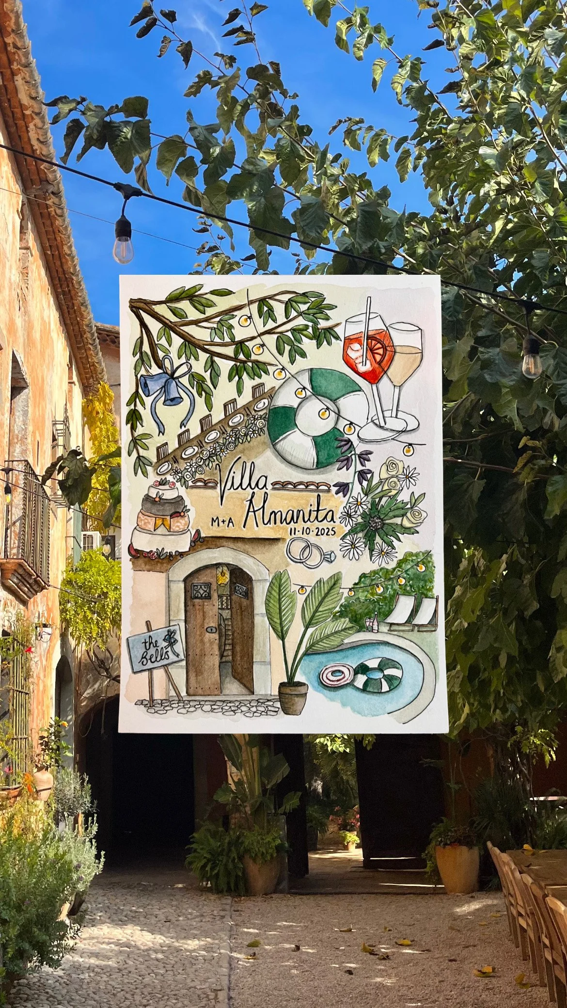 A colorful hand-drawn signboard for Villa Almanita, featuring illustrations of pool inflatables, drinks, flowers, plants, a fountain, and a building entrance, with the date 11-10-2025 and the name M+A.