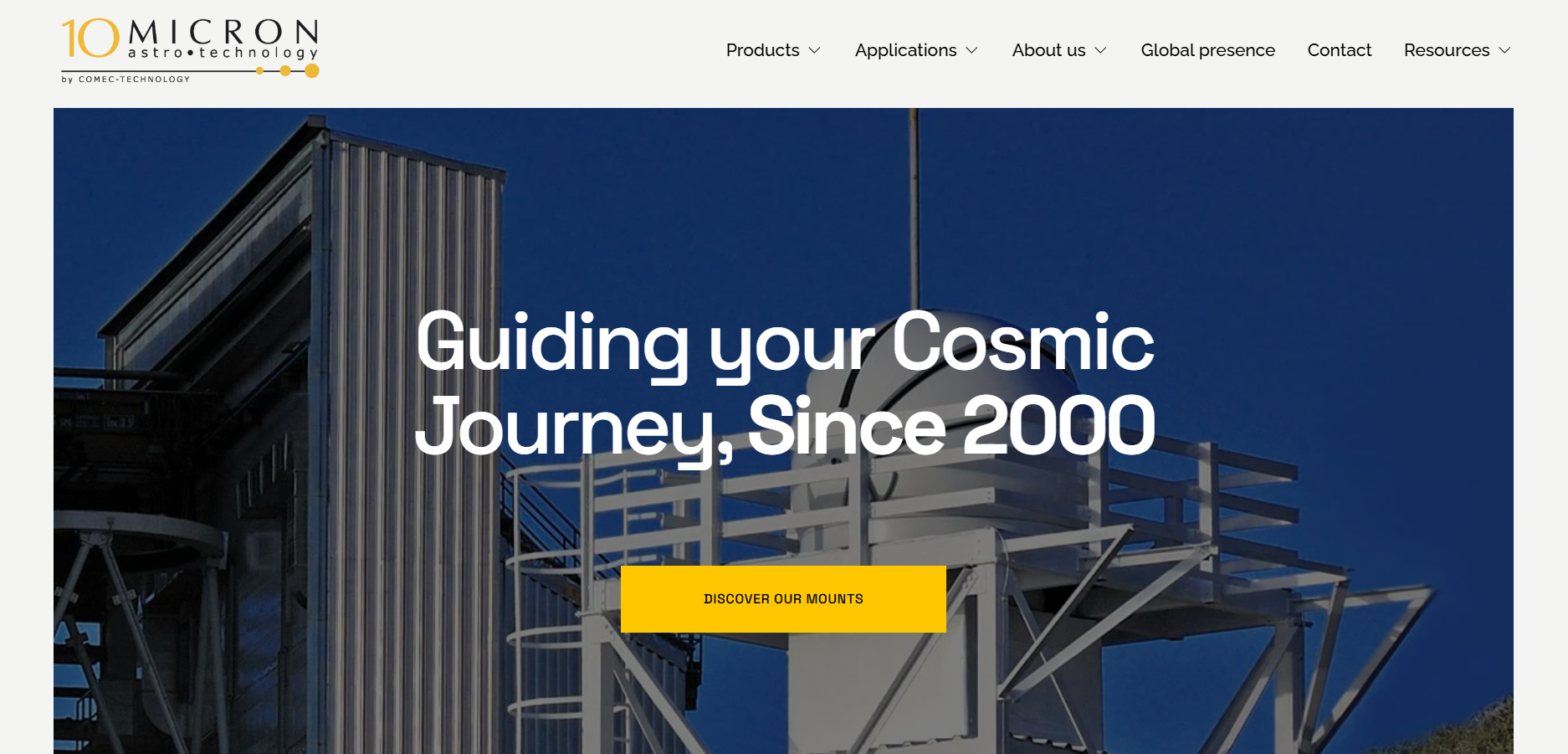 A website homepage for MICRON Astro-Technology featuring a large background image of a white telescope structure against a clear blue sky, with white and yellow text overlaying the image.