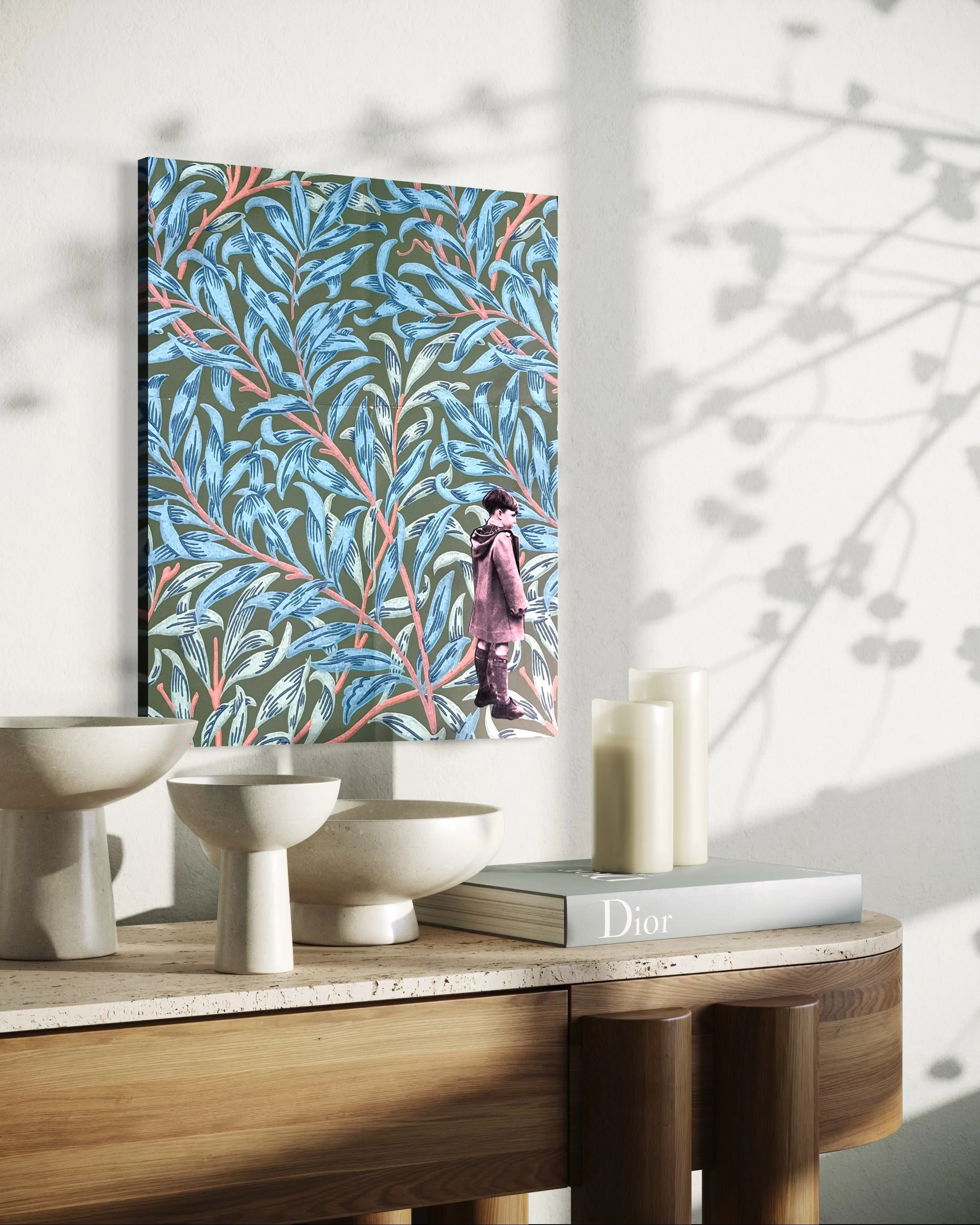 A decorated wall featuring a painting of a boy standing on a large leafy branch with blue and pink leaves. The painting is on a white wall, with decorative bowls and candles on a wooden sideboard below.