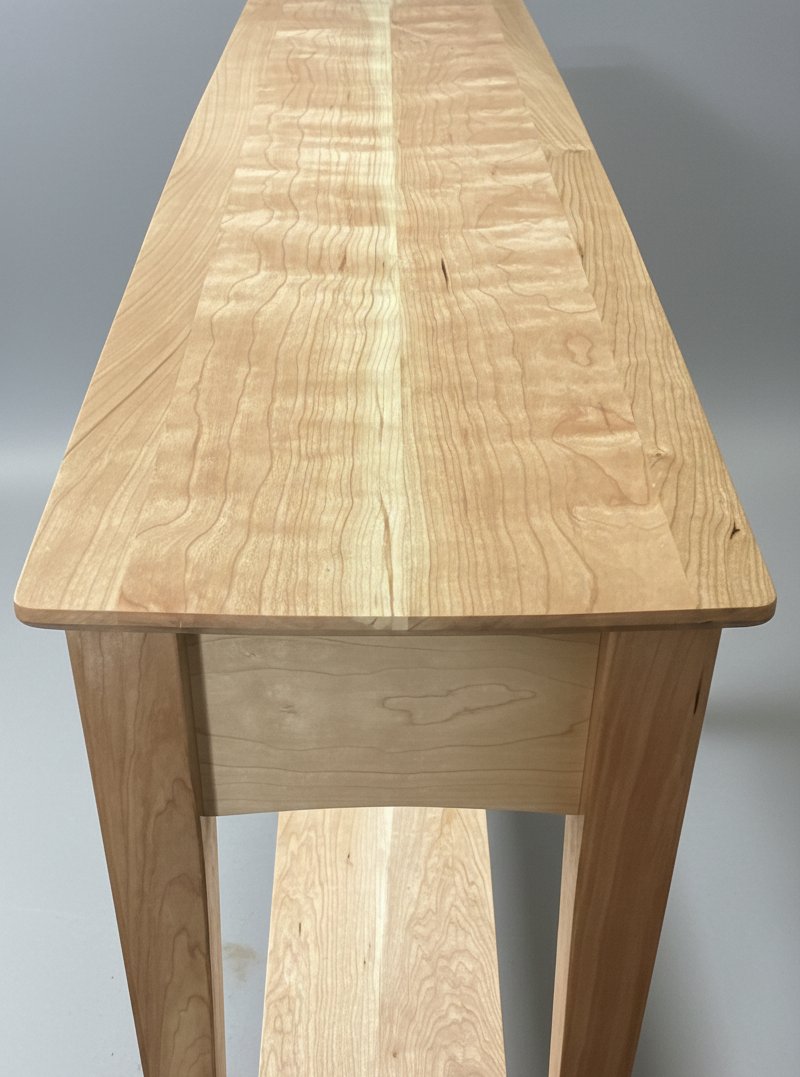 A wooden table with a smooth, natural finish and a sturdy design.