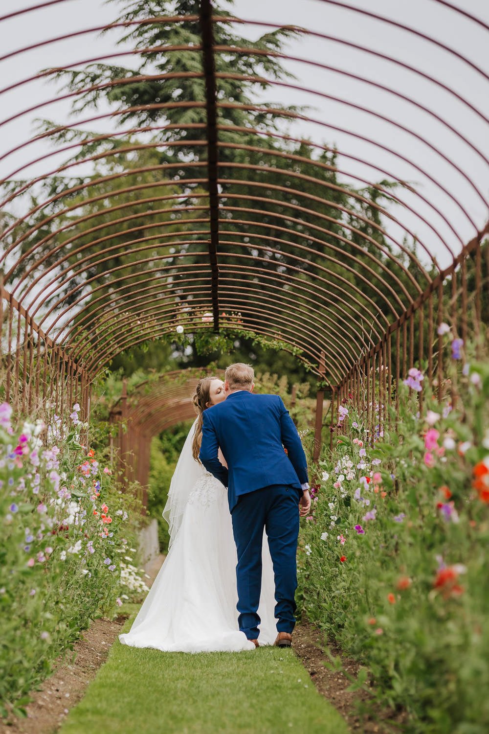 helmingham-hall-suffolk-wedding-venue-bride-groom-in-gardens-blue.jpg
