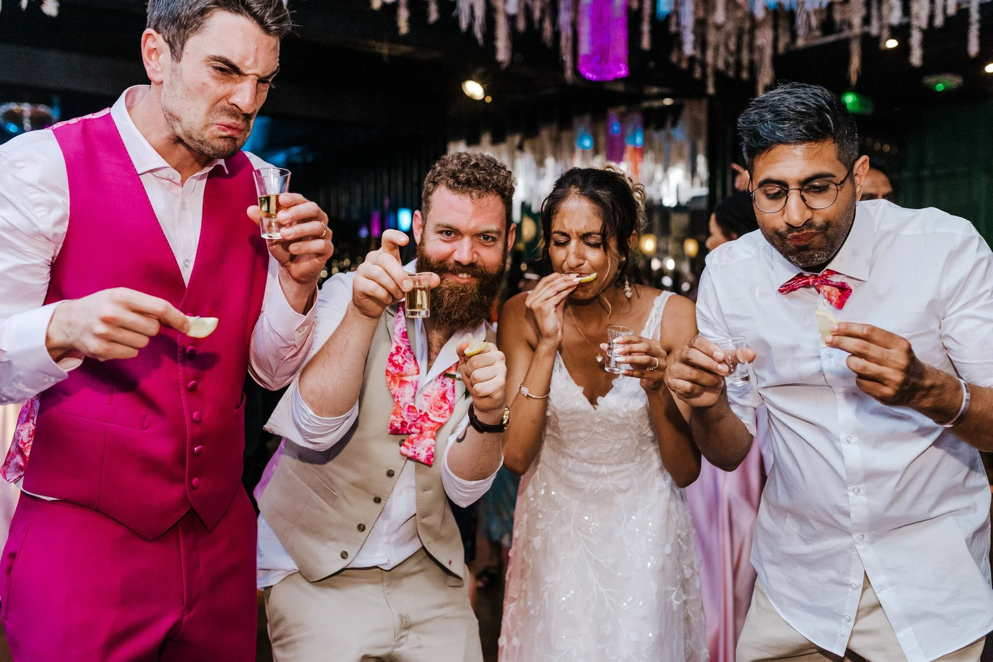 People at a celebration eating chips and drinking shots
