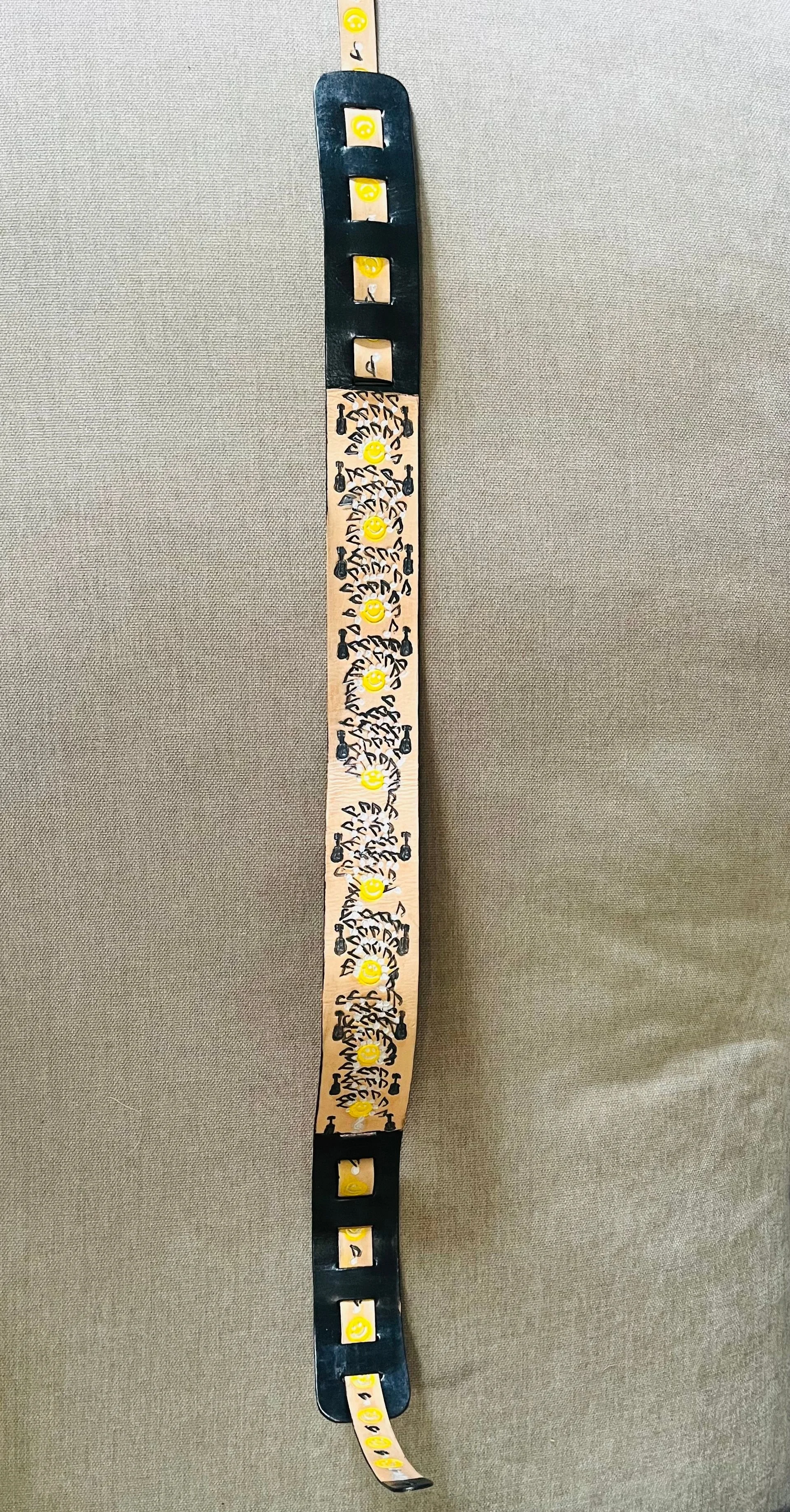 A strip of film with smiley face and black camera icons on a light background. The film strip has black borders and some sections are empty or have images of smiley faces.