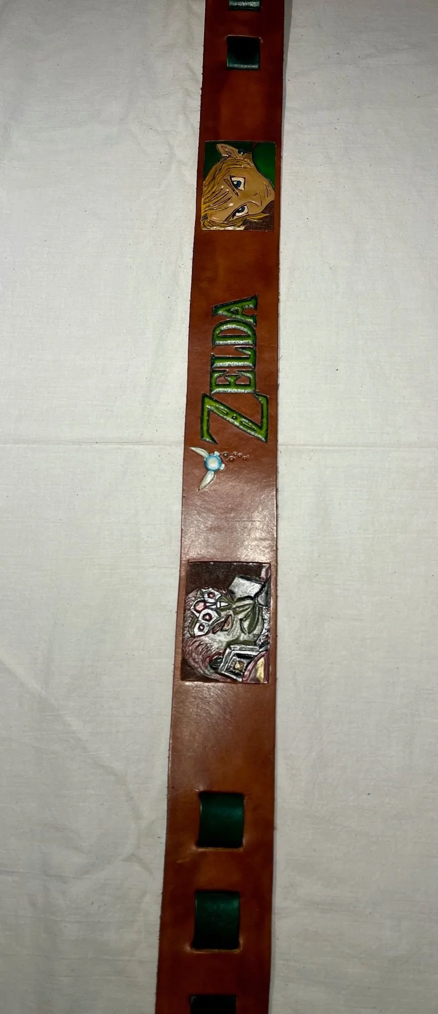 A decorative strip featuring the 'Zelda' logo, a fairy, a portrait of a character with blonde hair and pointed ears, and a scene with a tree and books.