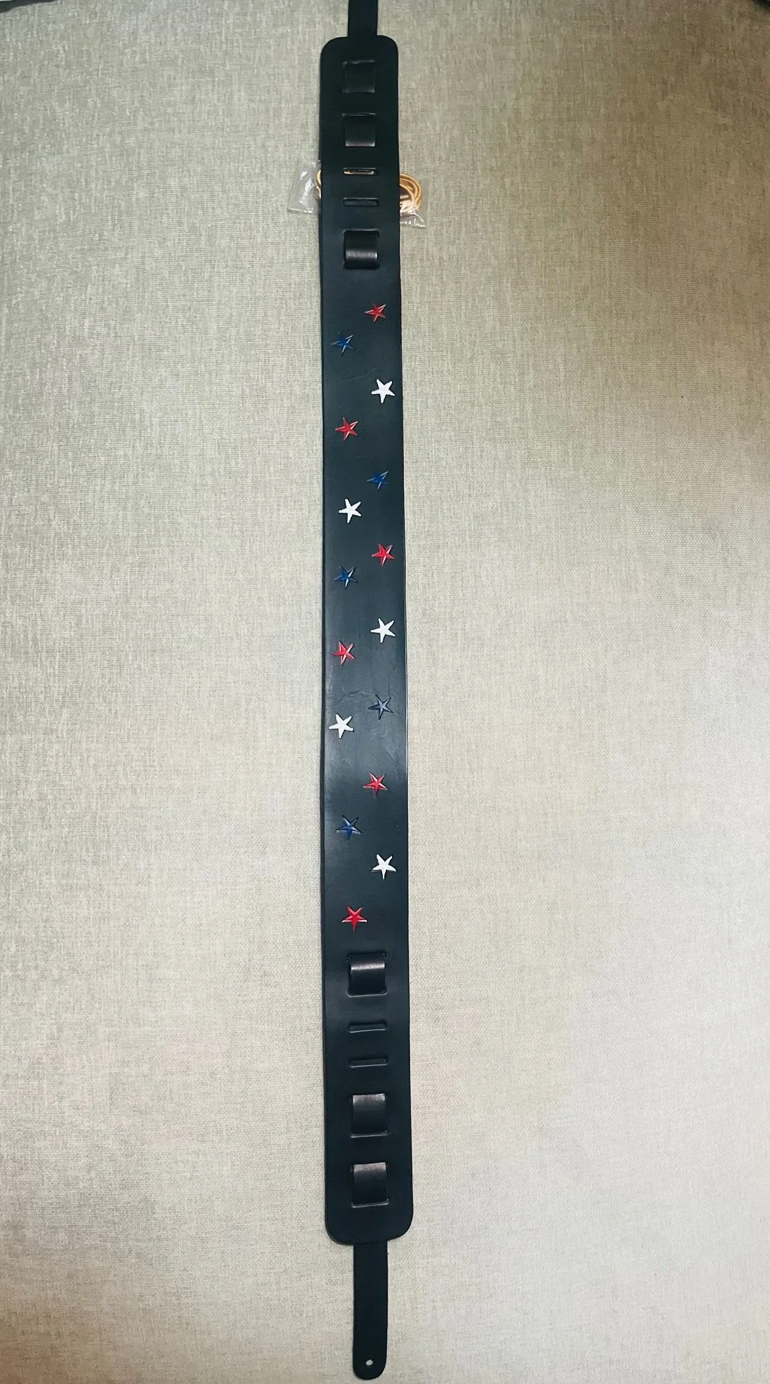 Black wristband with red, white, and blue star decorations.