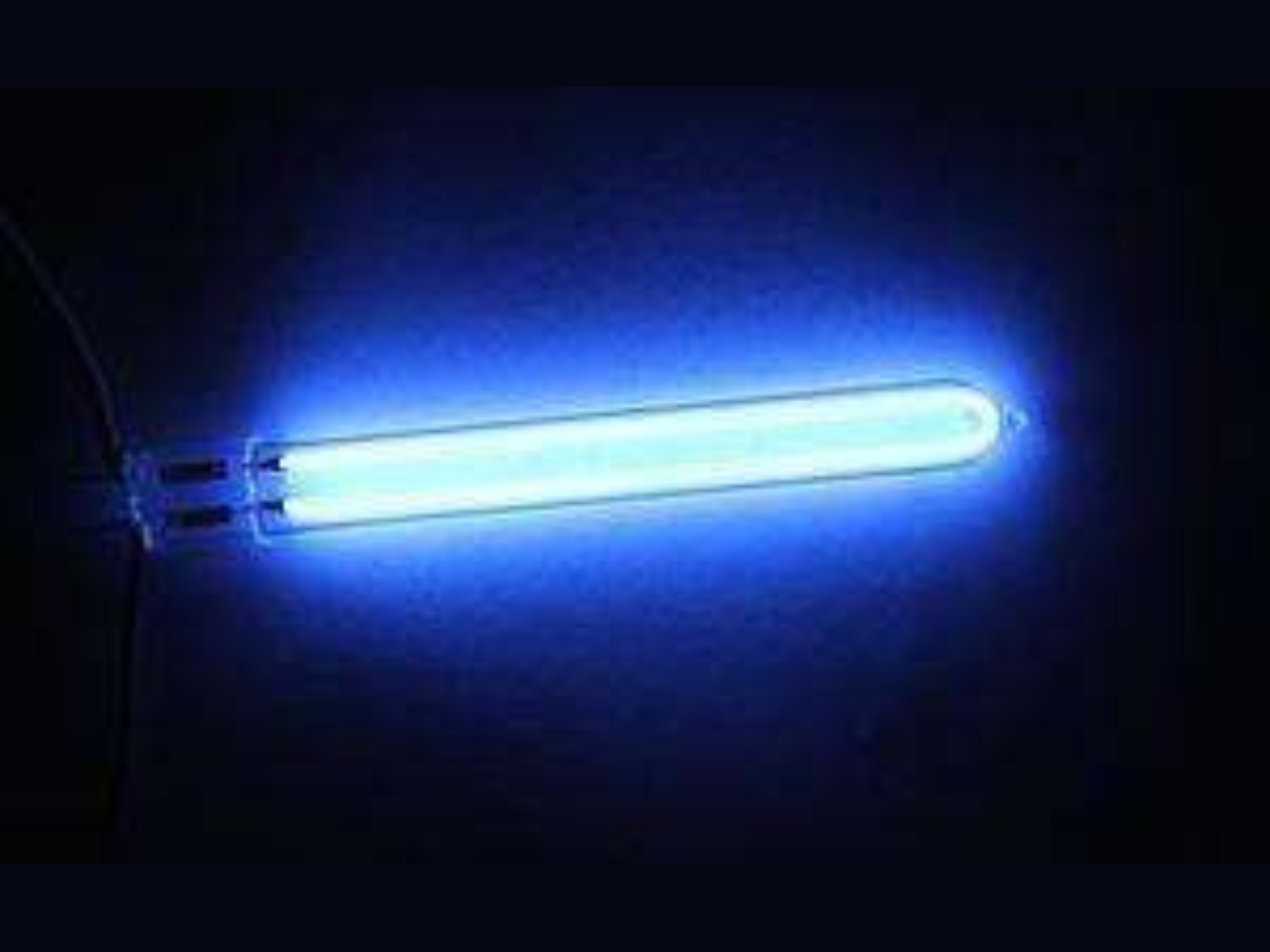 A blue ultraviolet light tube glowing in the dark.