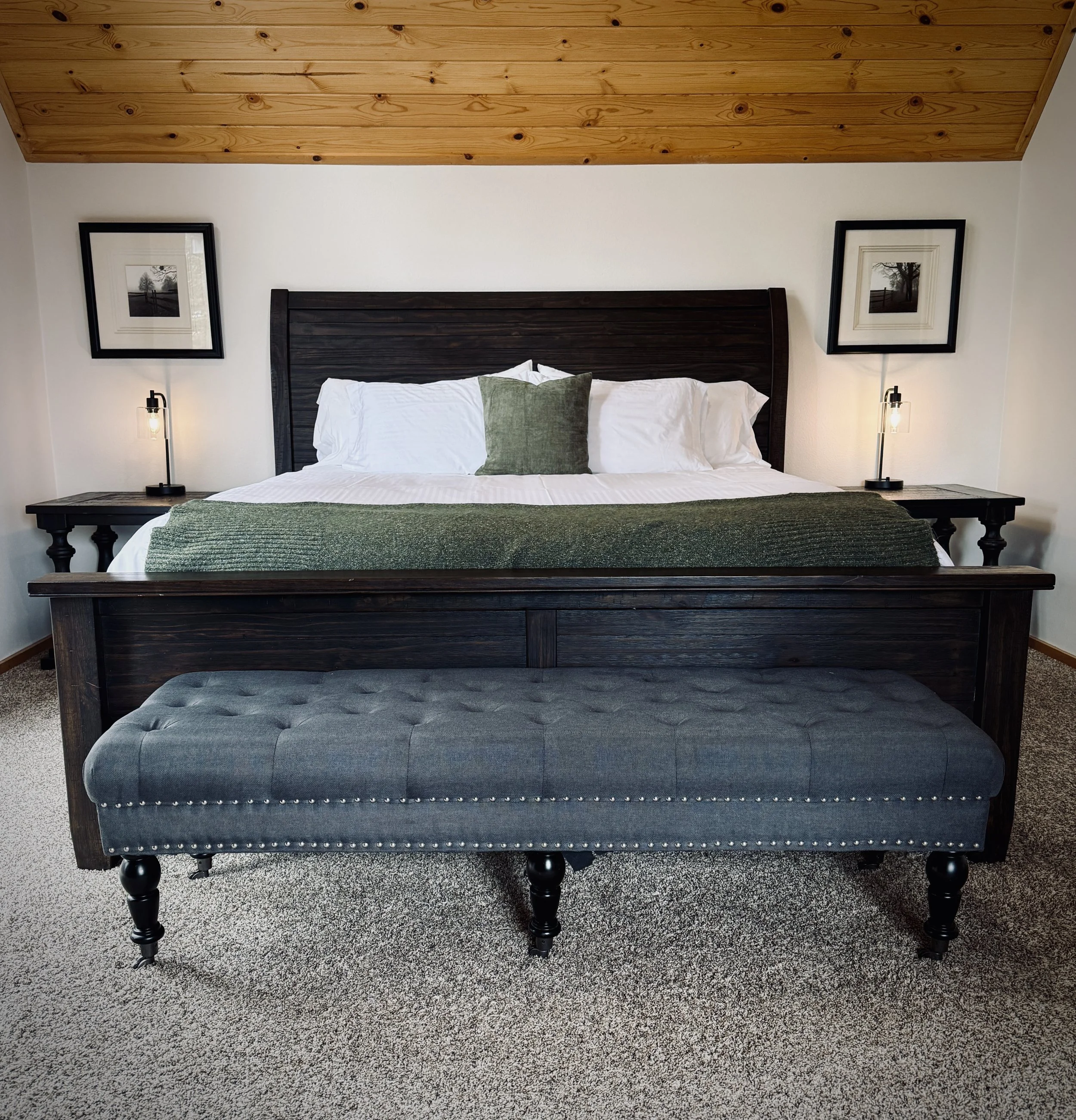 The Estate House primary bedroom is a refined retreat, blending comfort with timeless elegance.