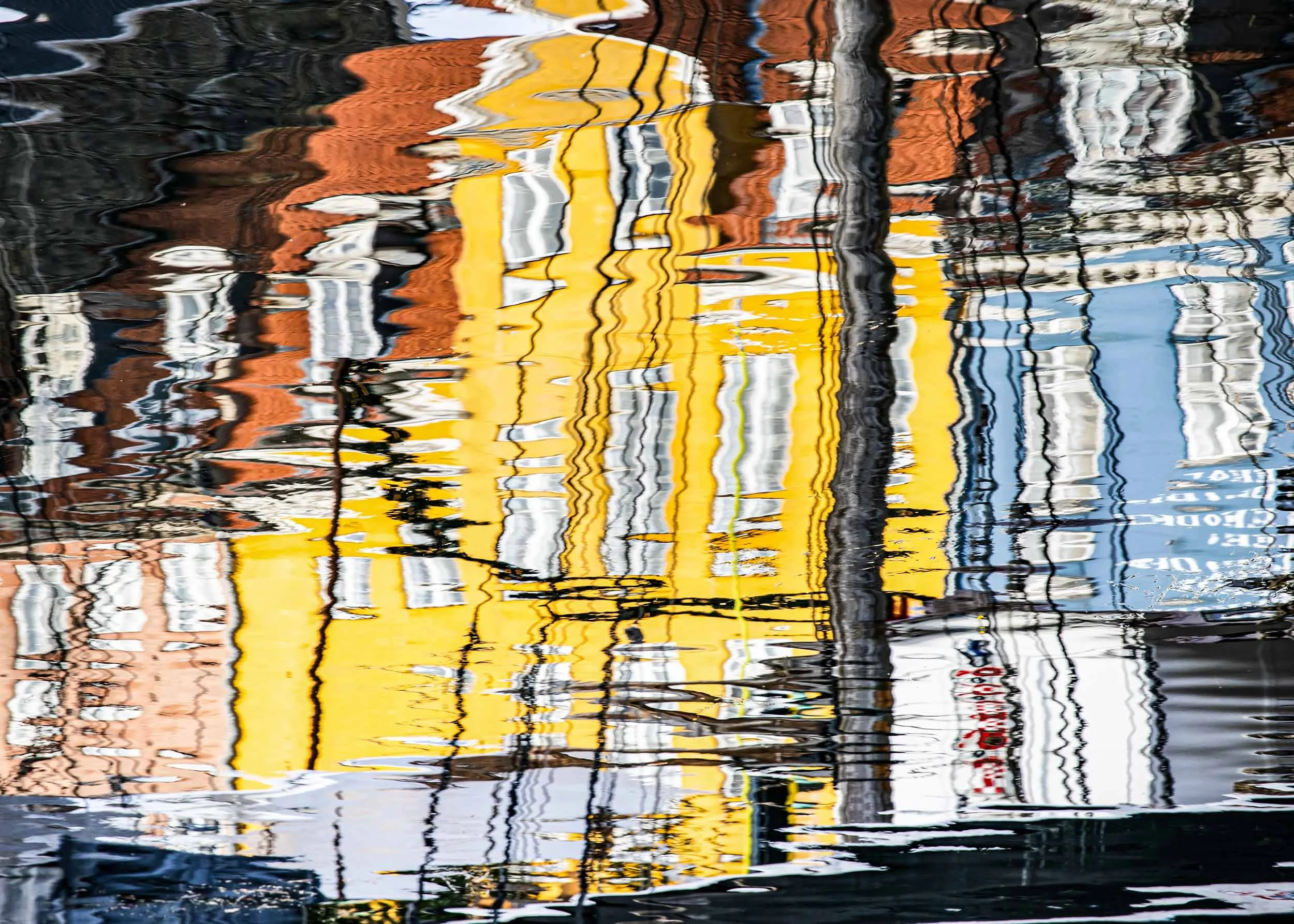 reflection houses and masts in water  in copenhagen catherinelewisphotography.jpg