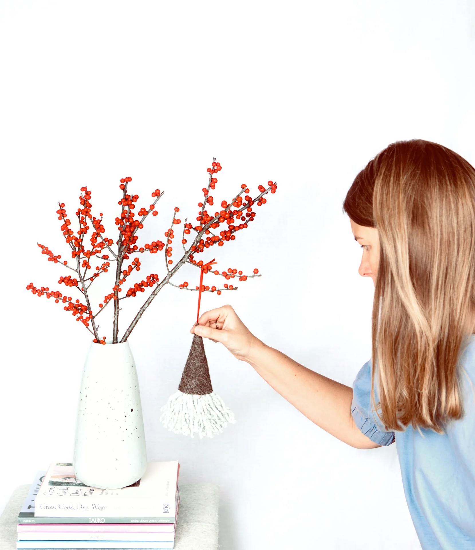image of a sewing entrepreneur haning her decorations on a christmas winter display.jpg