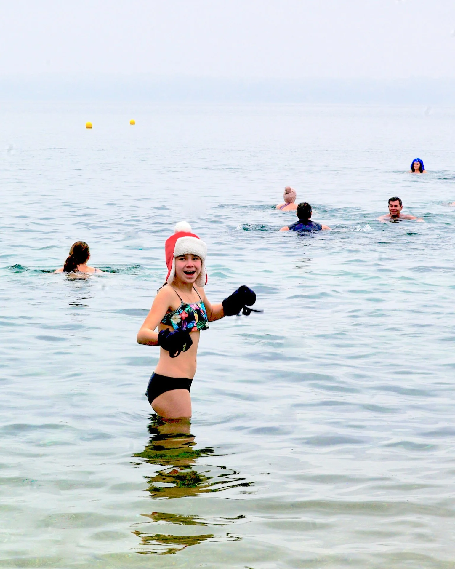 a girl swimming in the winter in lake geneva catherinelewisphotography.jpg