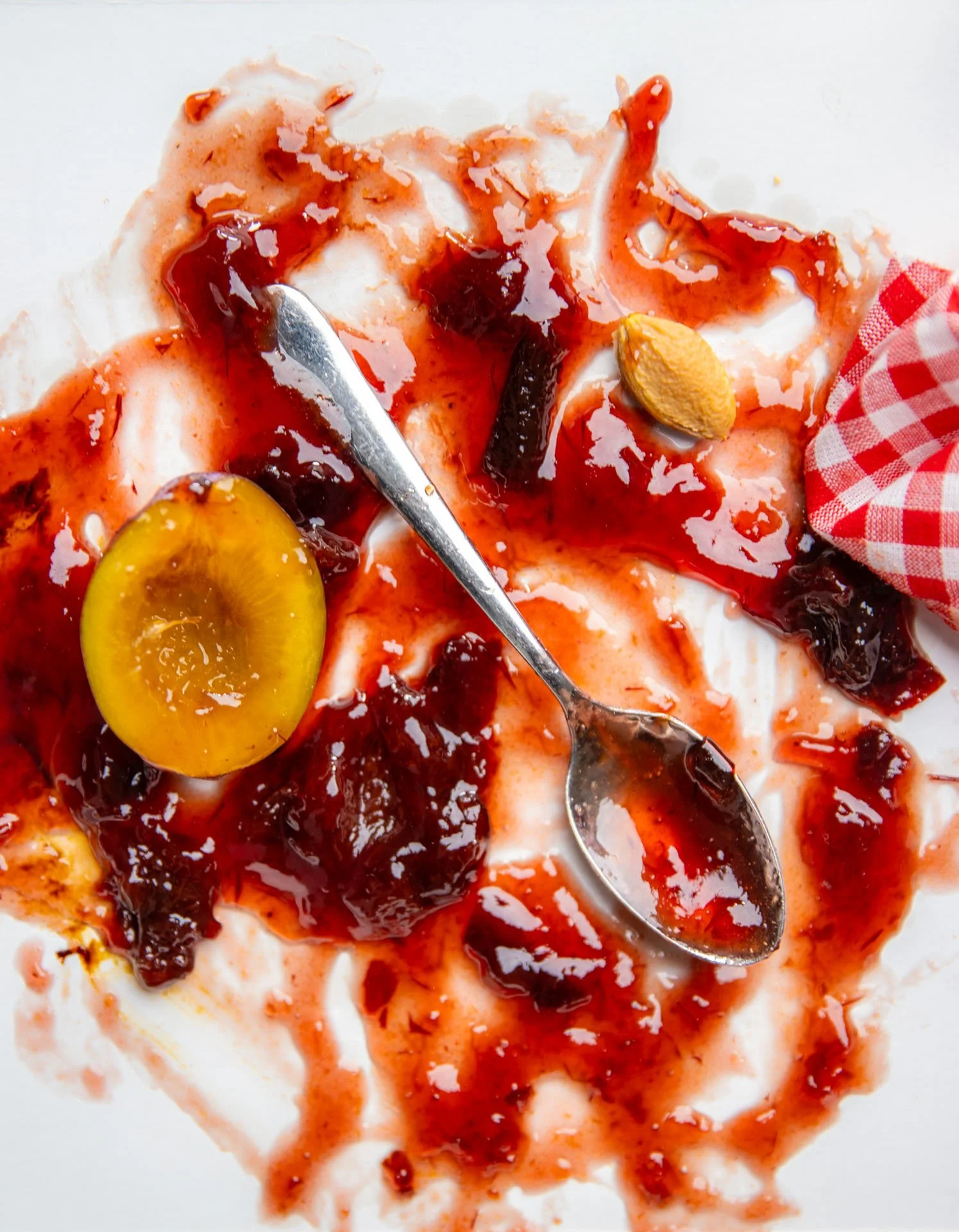 a fine mess of plum jam on a spoon catherinelewisphotography.jpg