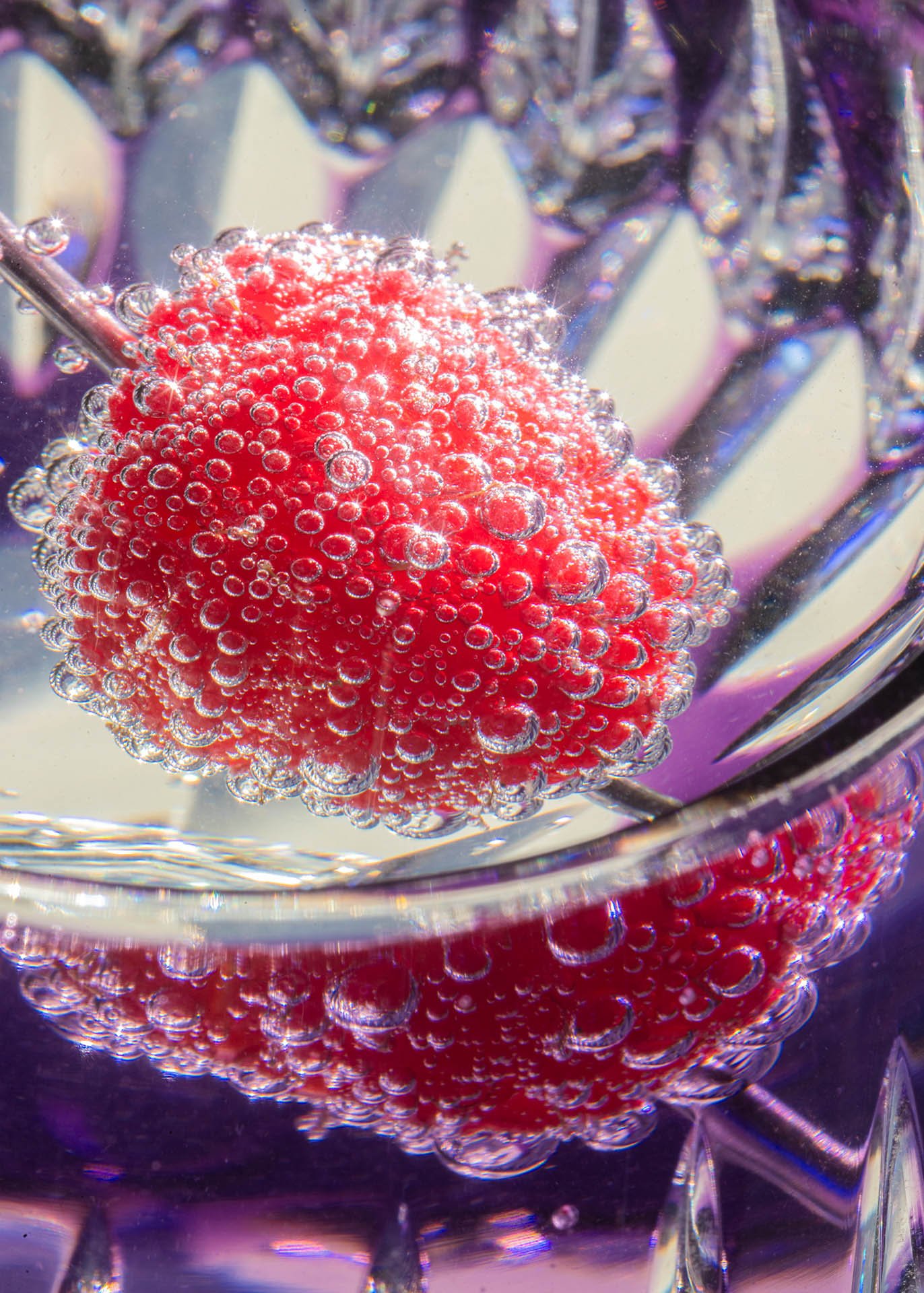 a raspberry in a wineglass covered in bubbles catherinelewisphotography.jpg