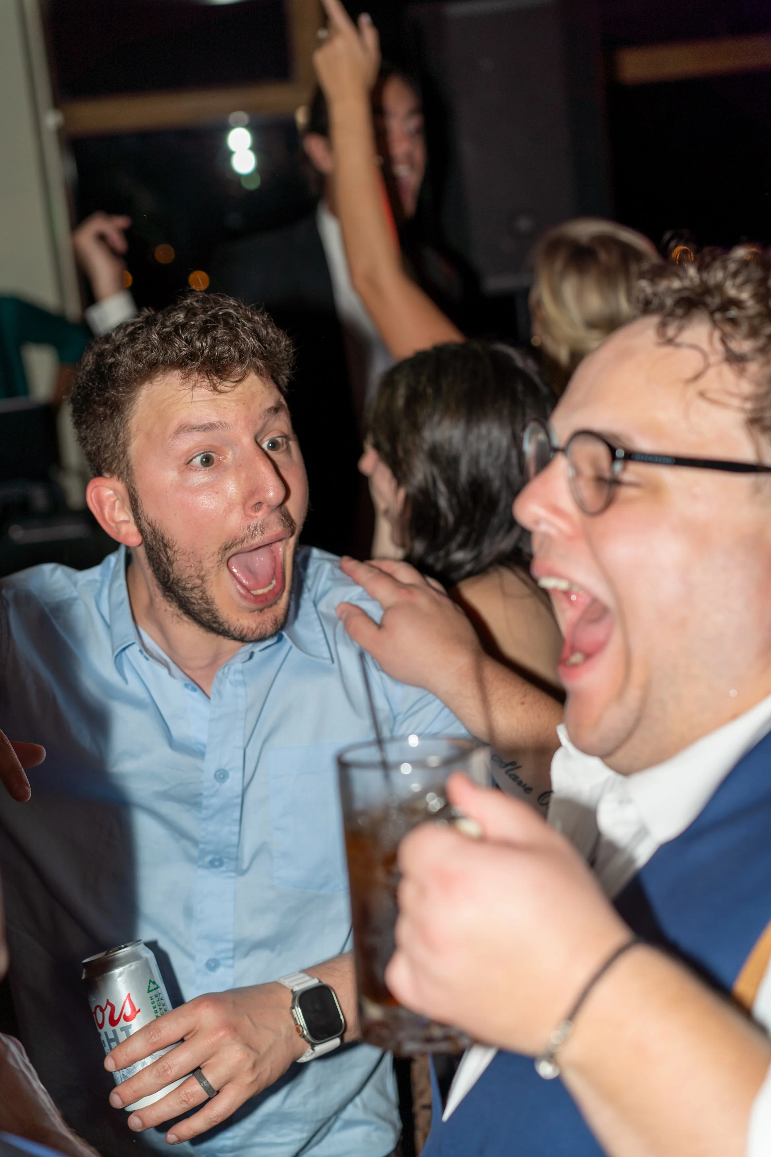 Group of friends celebrating, laughing, and enjoying drinks at a party or gathering.
