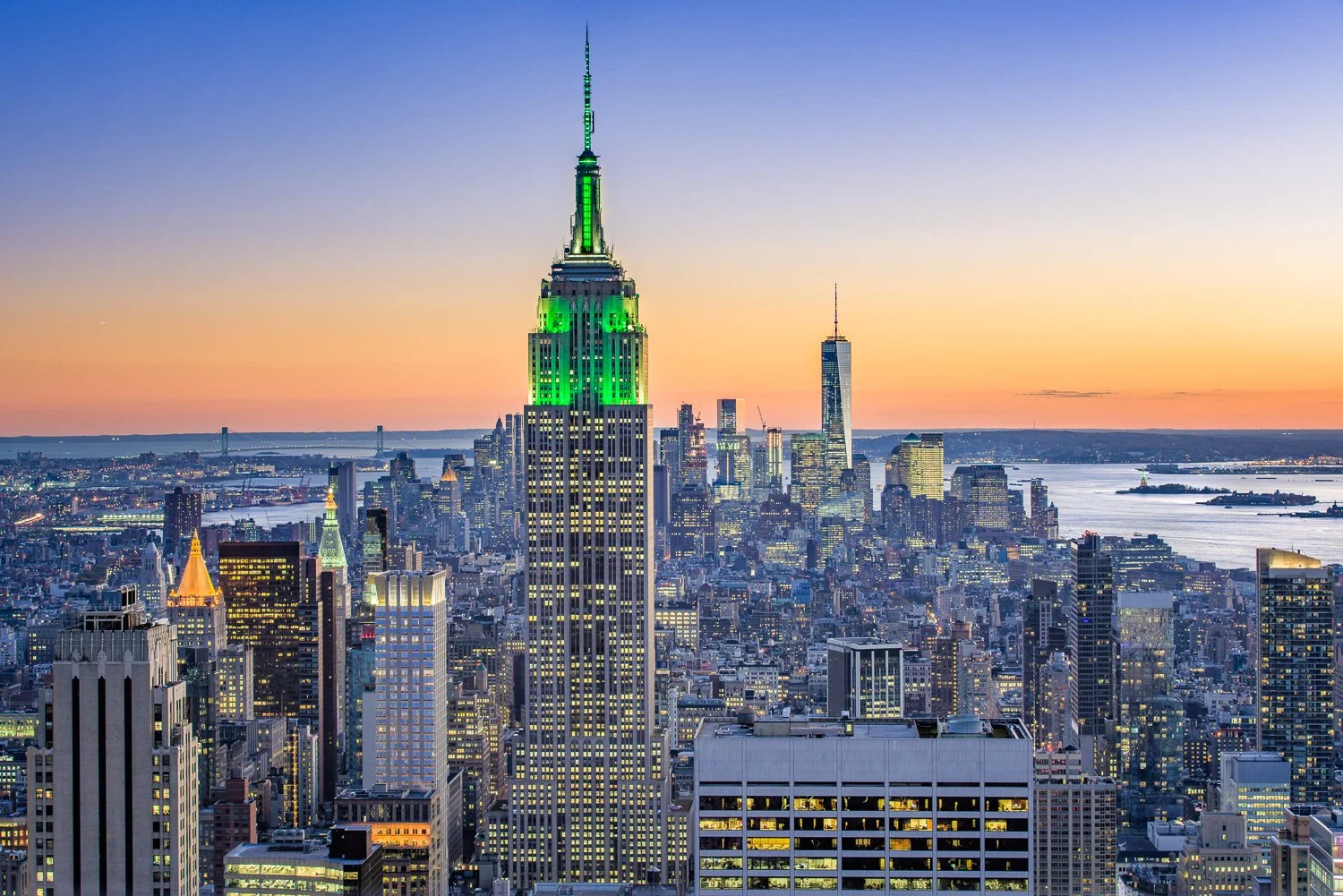 Aerial view of Manhattan skyline at sunset with Empire State Building illuminated in green lights.  I took this shot from the "Top of the Rock" (Rockefeller Tower).  I could not bring my tripod as it is not allowed and since it was dusk requiring a l