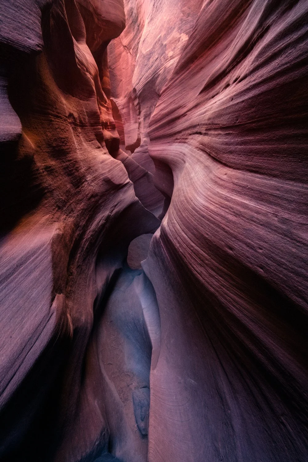 Narrow slot canyon with smooth, multicolored sandstone walls in Arizona