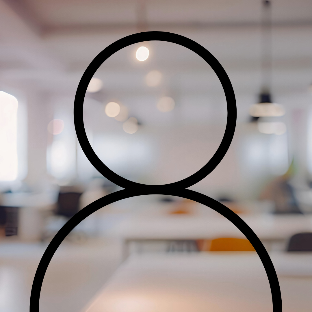 Blurry interior of a modern office space with hanging pendant lights and large windows, with an outlined user icon overlay.