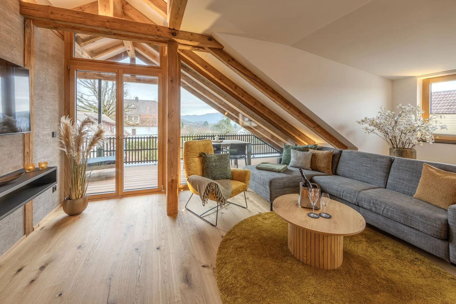 Moderner Wohnzimmerbereich, große Holz-Aluminium-Fenster, viel Licht, nachhaltig, energieeffizient