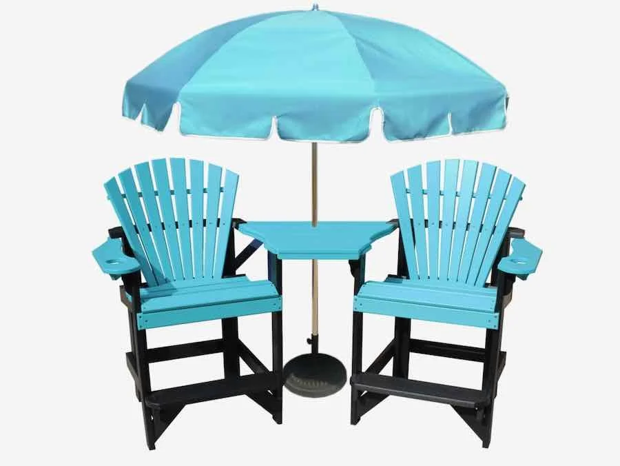 Two blue Adirondack chairs with armrests and a small blue table between them, shaded by a large blue patio umbrella.