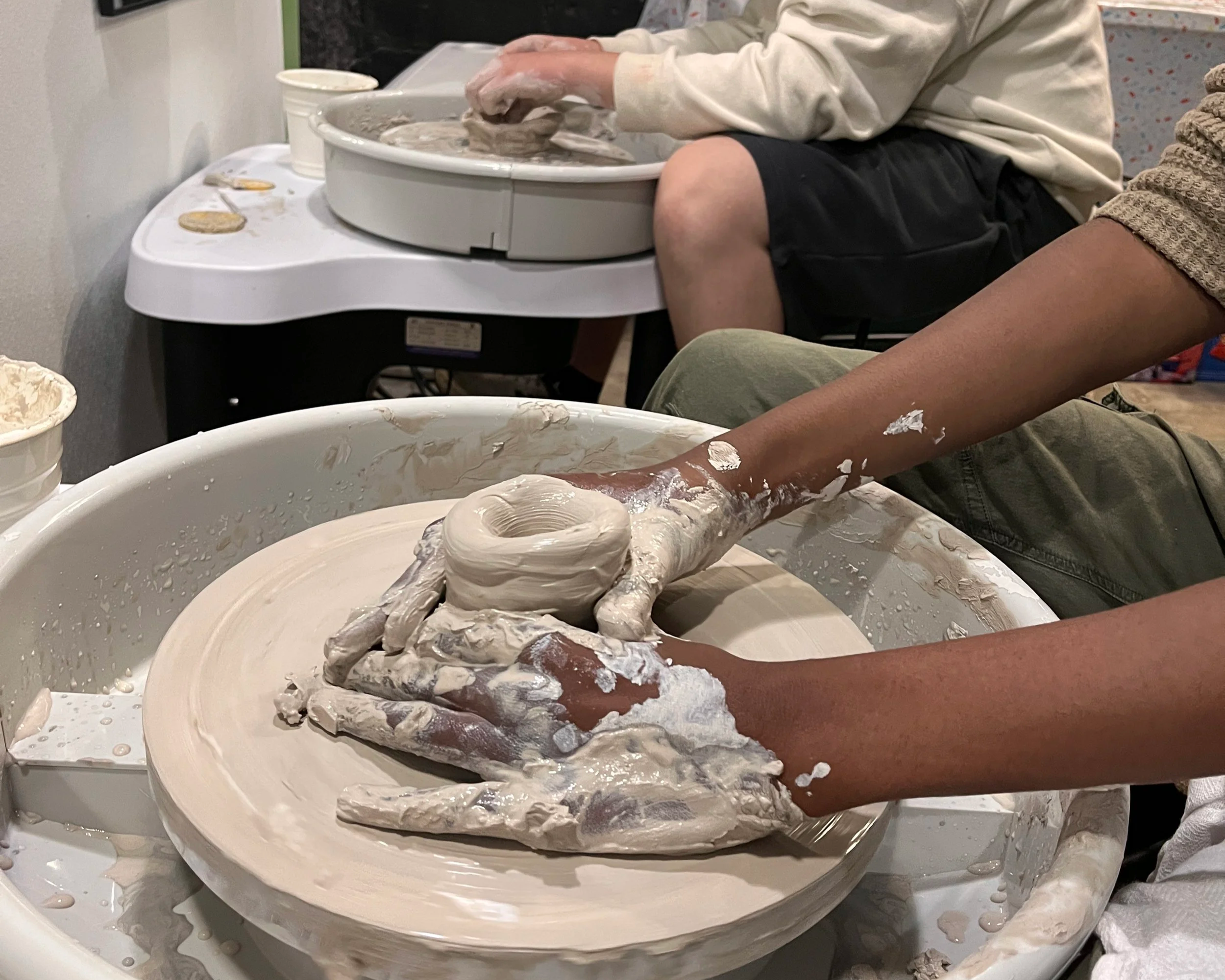 Teens at pottery wheels