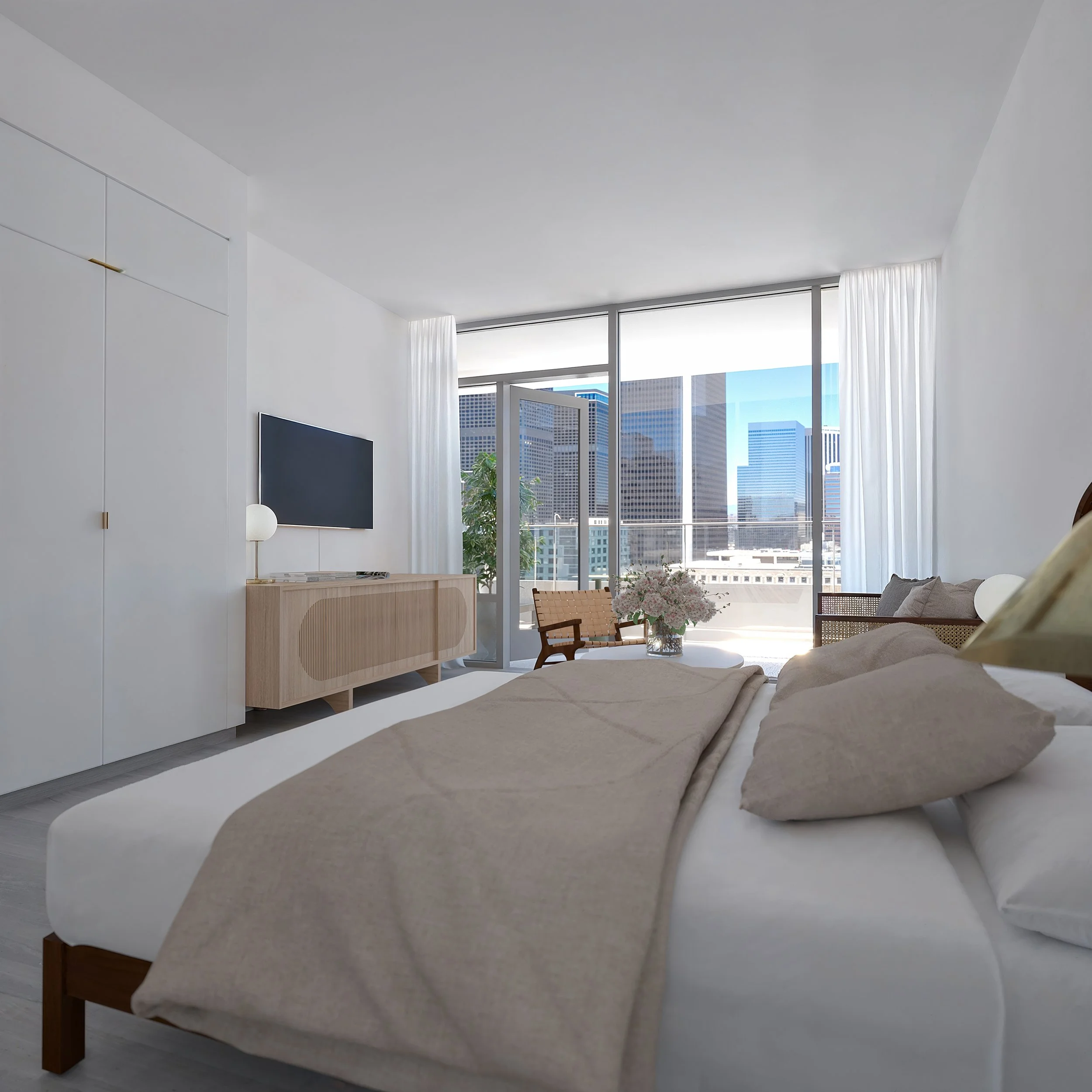 Modern hotel room with a large bed, beige bedding, and a window with a cityscape view, including tall buildings and blue sky.