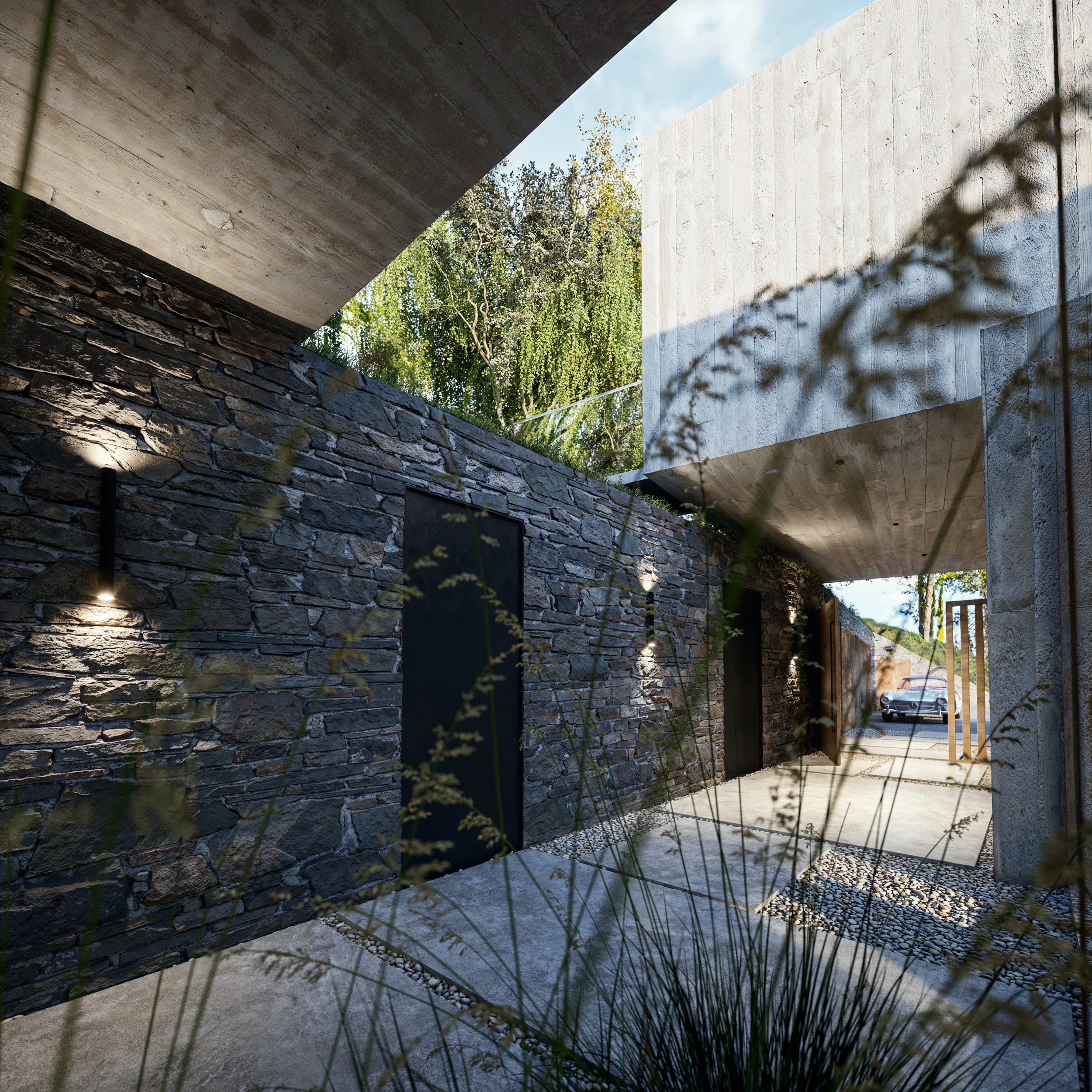 Modern building exterior with stone and concrete walls, outdoor lighting, and a view of a car parked outside.