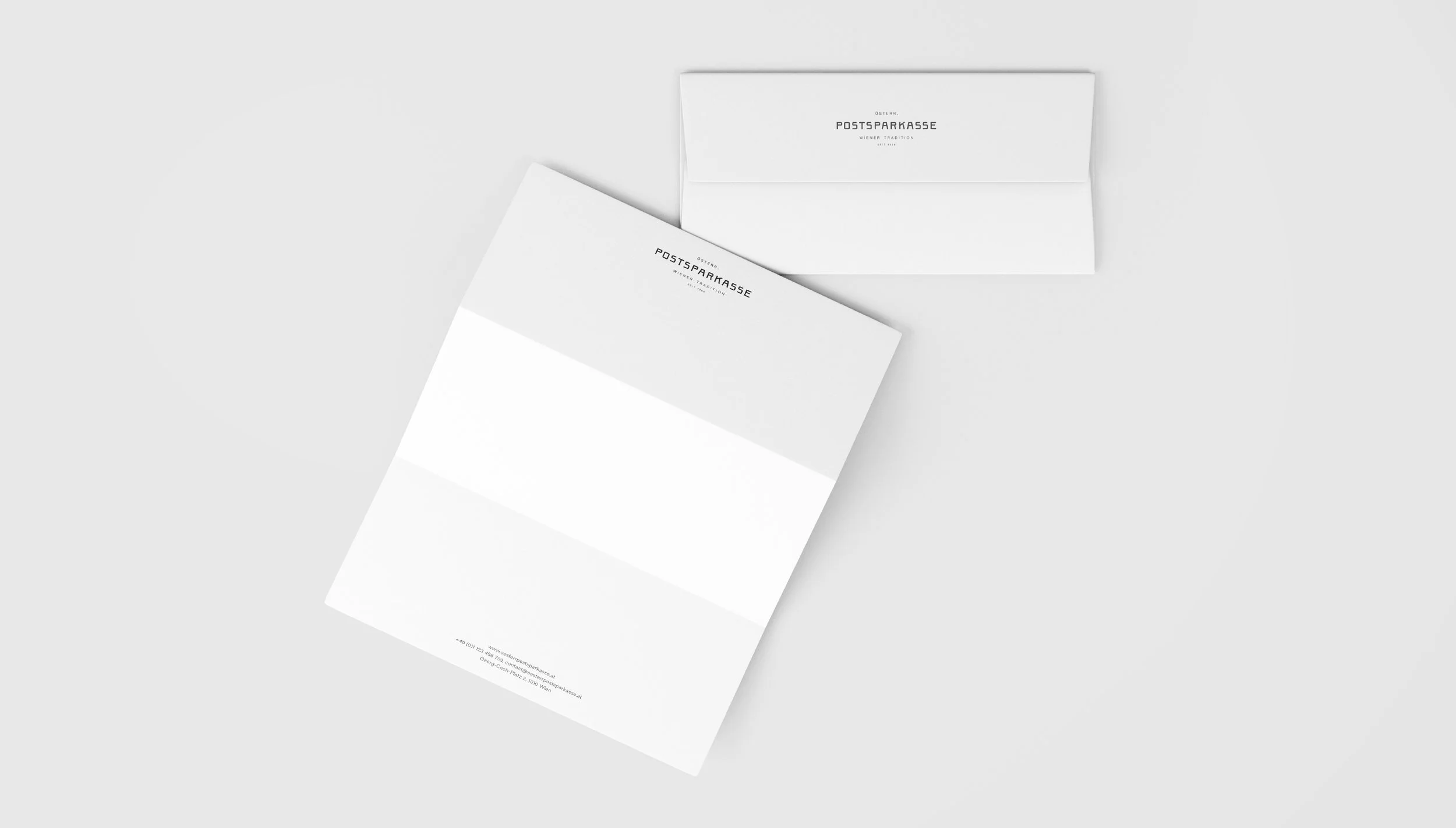 Two white business envelopes with black text on a light gray background.