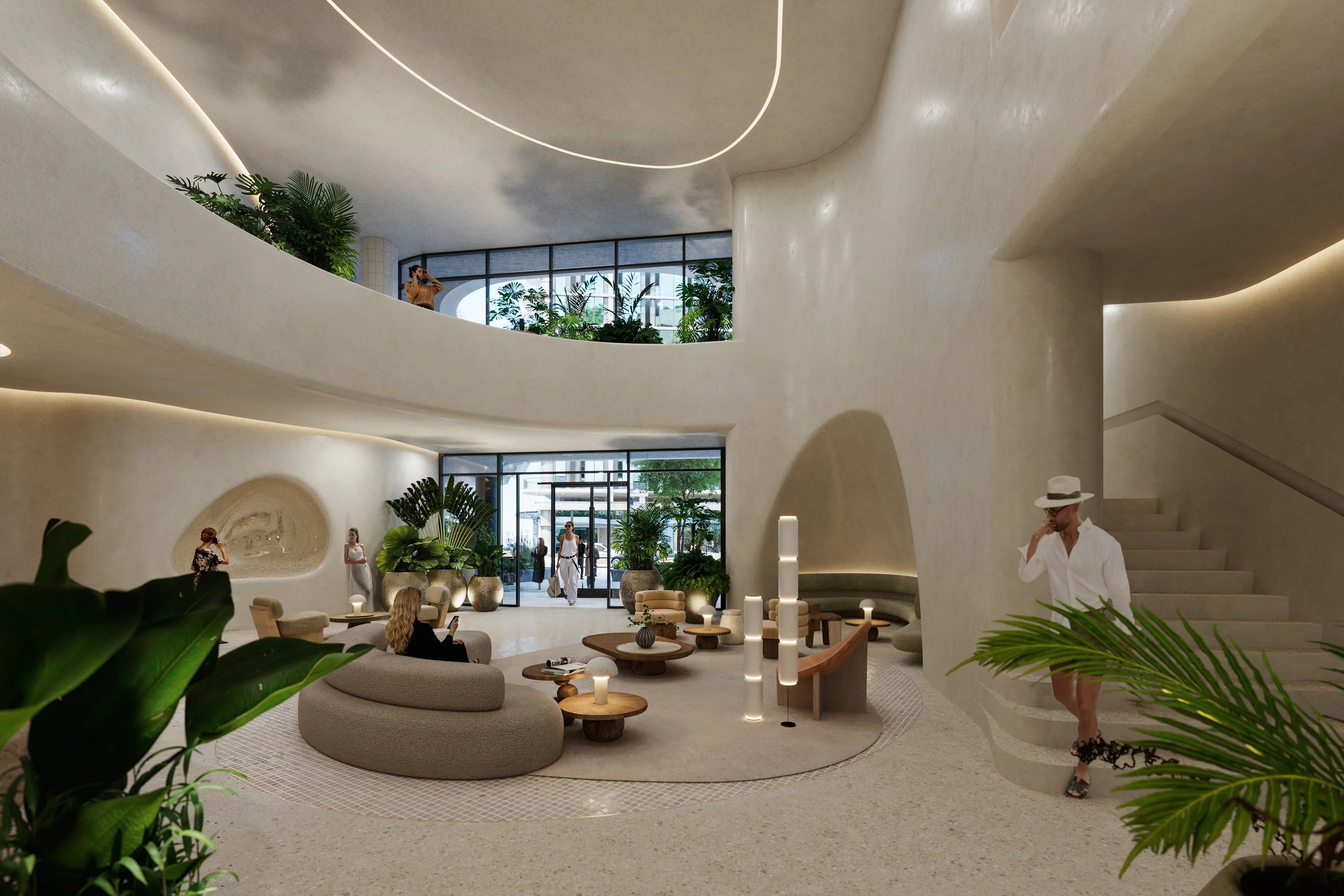 Modern hotel lobby with curved beige walls and glass storefronts, green plants, and contemporary seating areas. Several women, some using phones, are scattered throughout the space, and a man in white shirt and hat is talking on his phone near the st