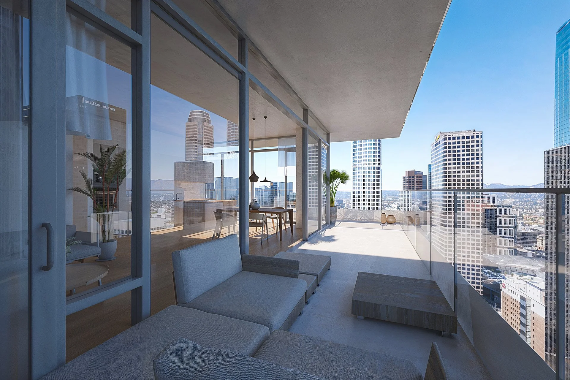 Modern apartment balcony with glass railing overlooking a city skyline with tall skyscrapers under a clear blue sky.