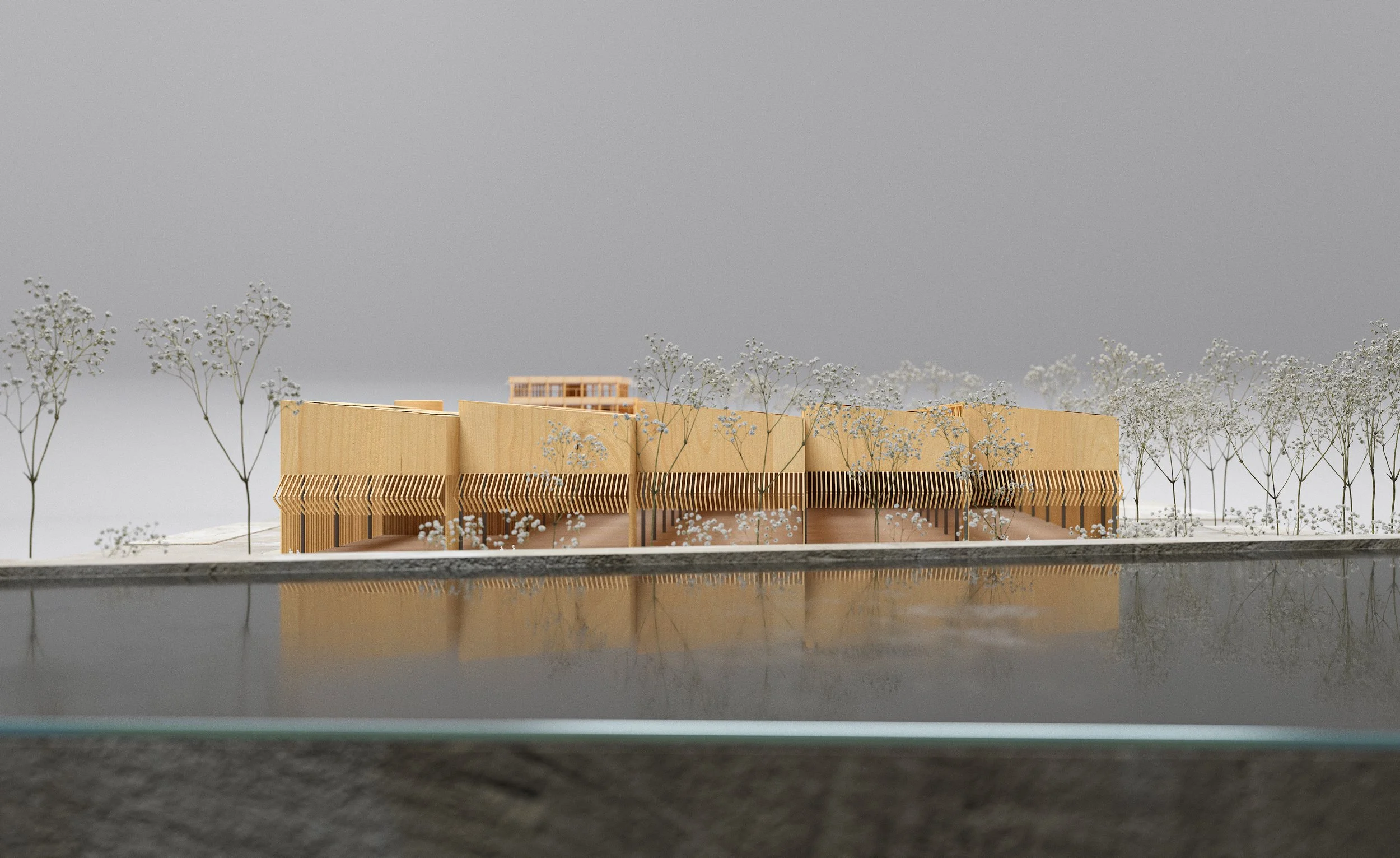 A scaled architectural model of a building with a modern design, featuring wooden elements and a slatted facade, surrounded by model trees and reflected in a water surface.