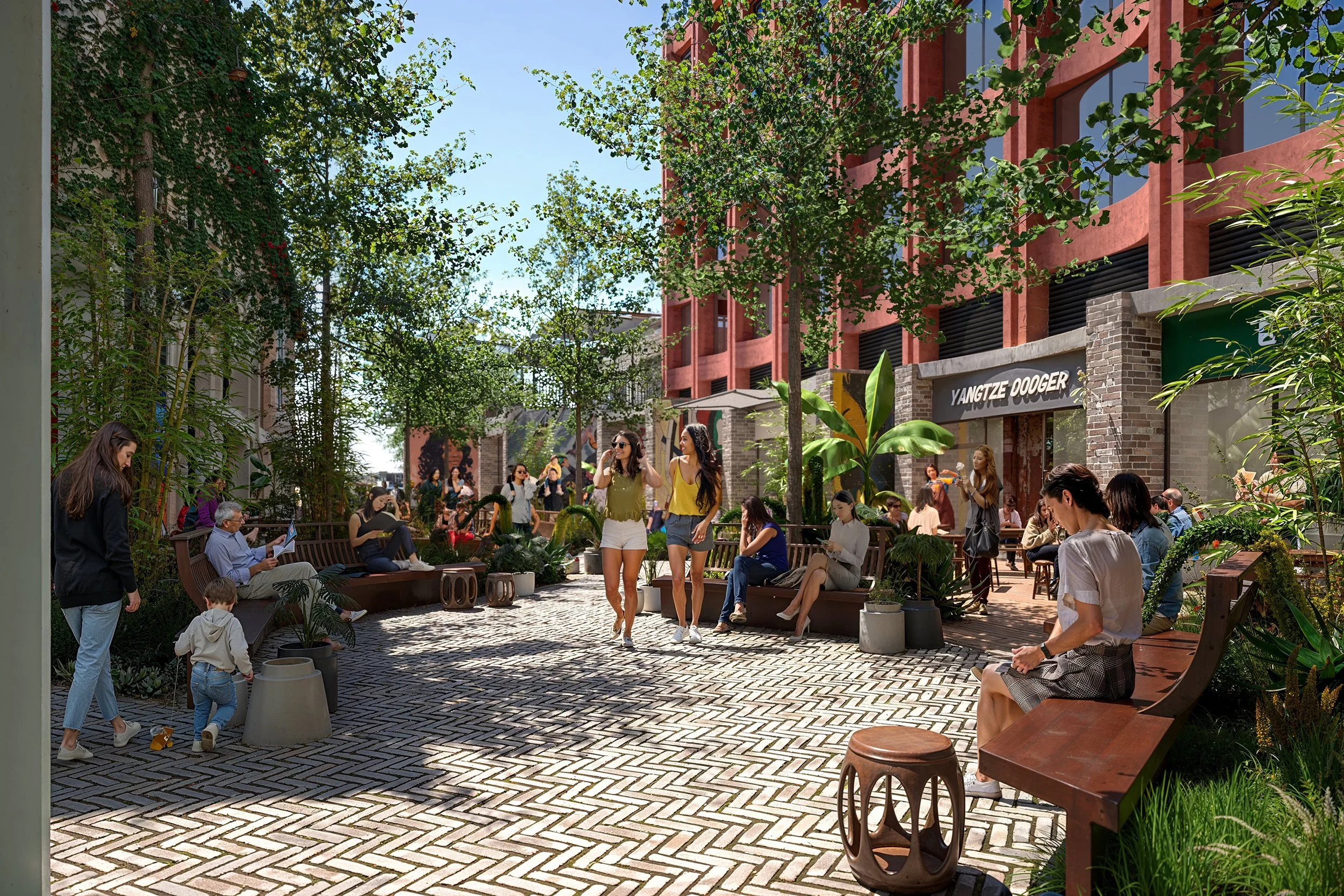 Outdoor urban patio with people sitting on benches and walking, surrounded by trees and plants, in front of red brick buildings with a sign that reads 'YANGTZE DOOGER' on one of them, under clear blue sky.