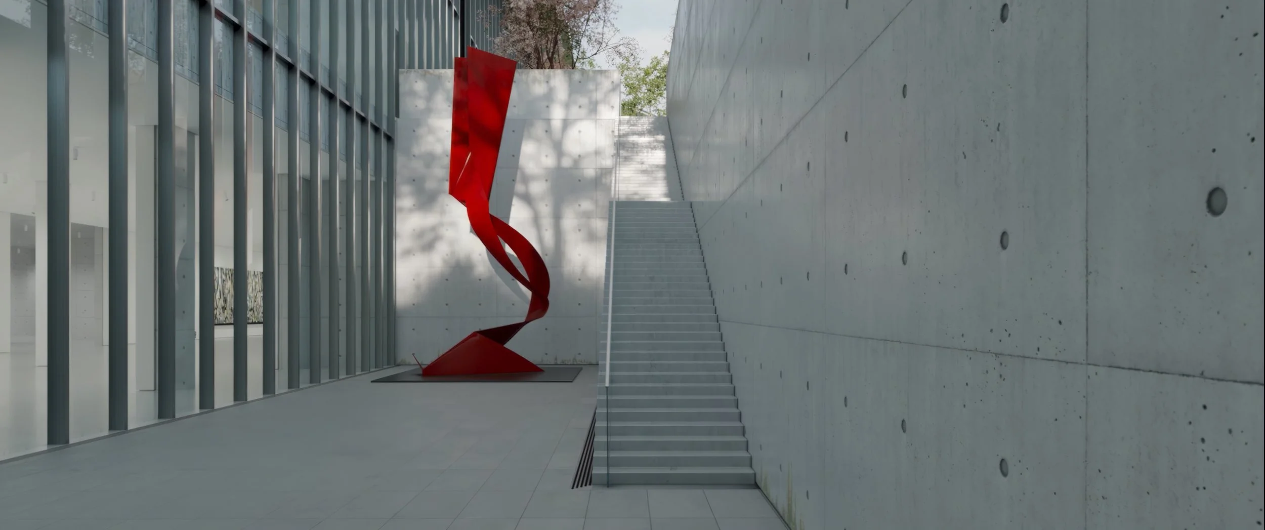Modern building exterior with a red abstract sculpture near stairs, concrete walls, and large glass windows.