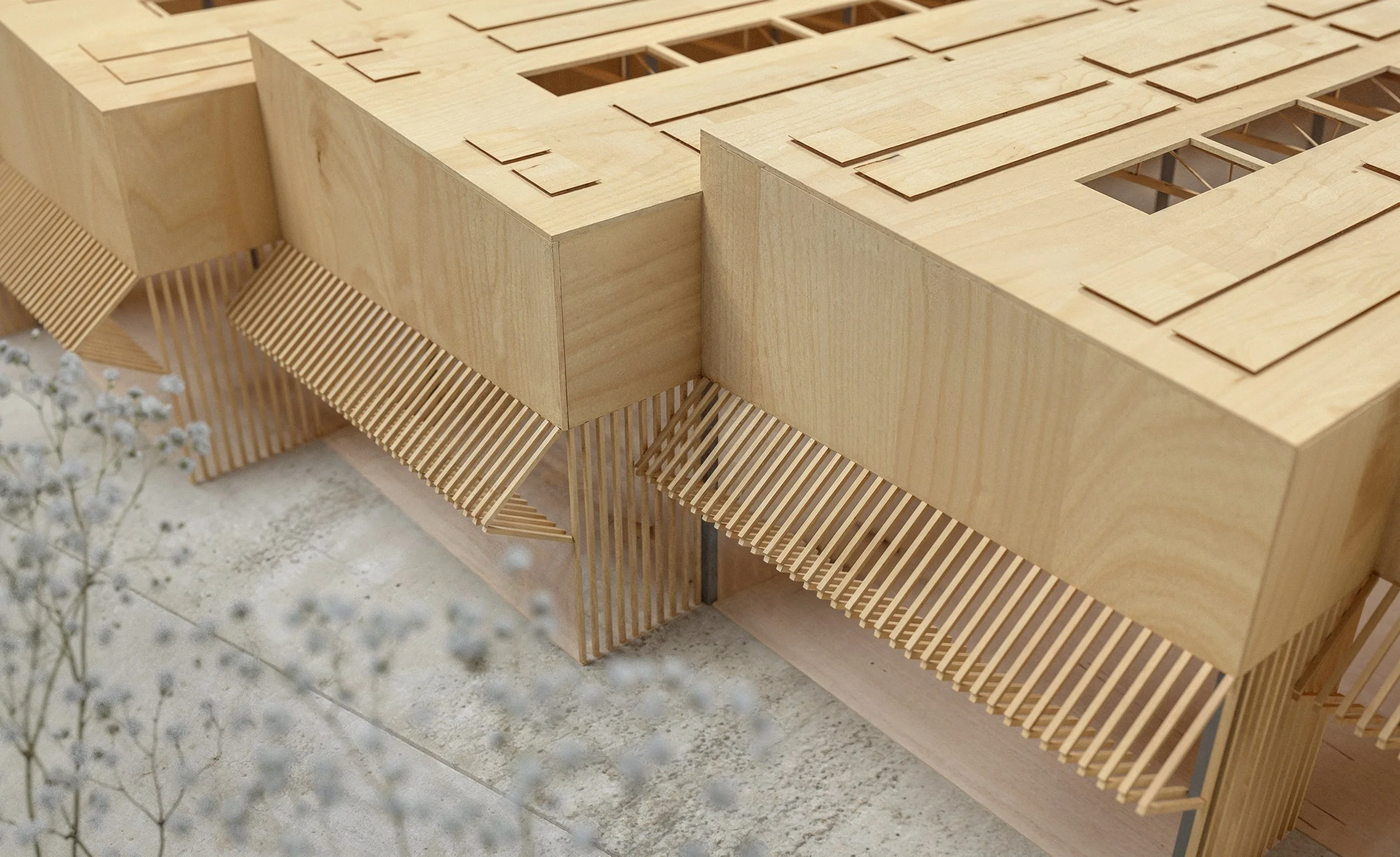 Architectural wooden model of a modern building with slatted and cut-out design details.